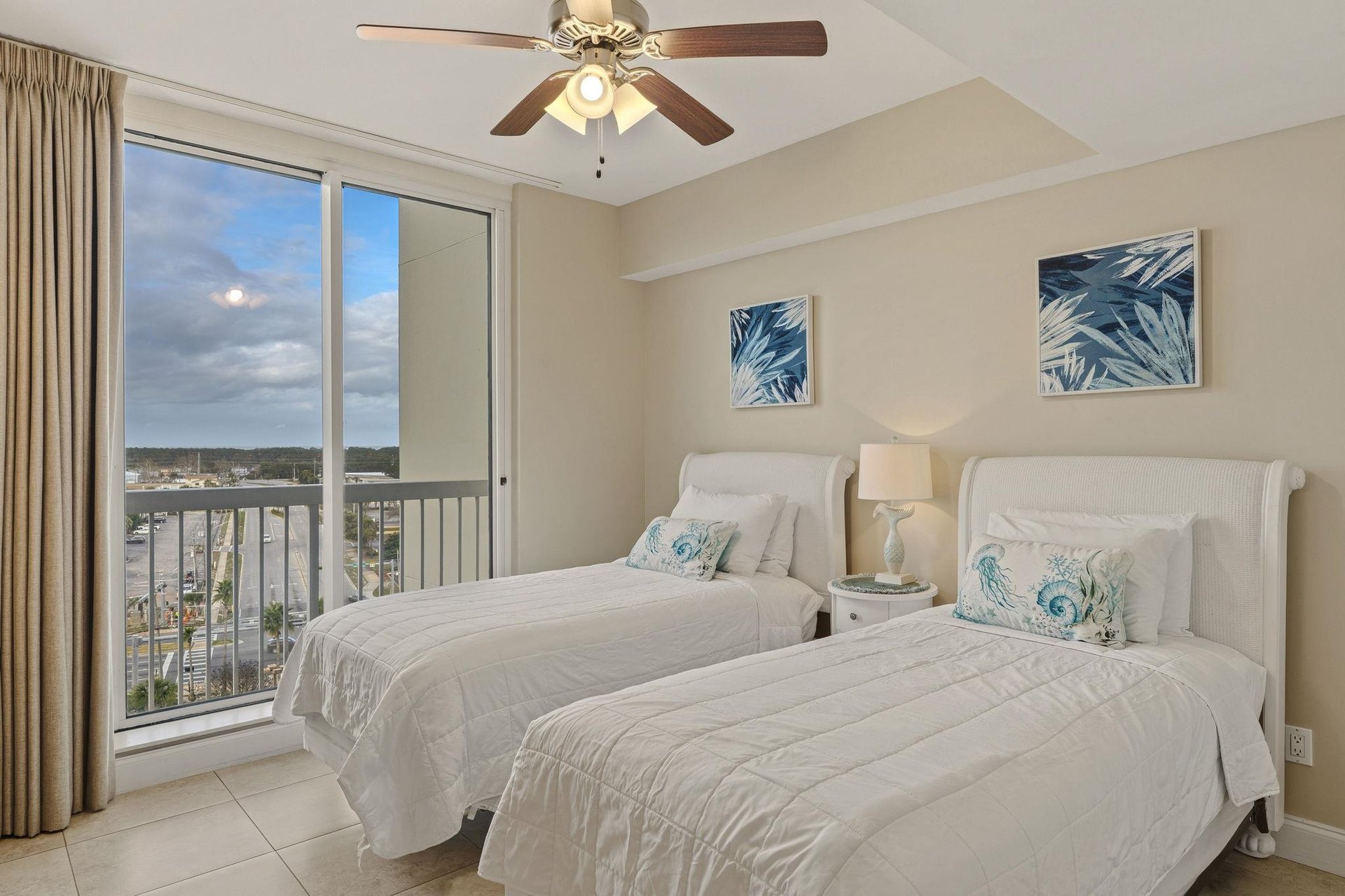 Bedroom 3 Wake up to stunning views from your bright twin bedroom, where coastal artwork and gentle ceiling fan create the perfect beachside retreat.