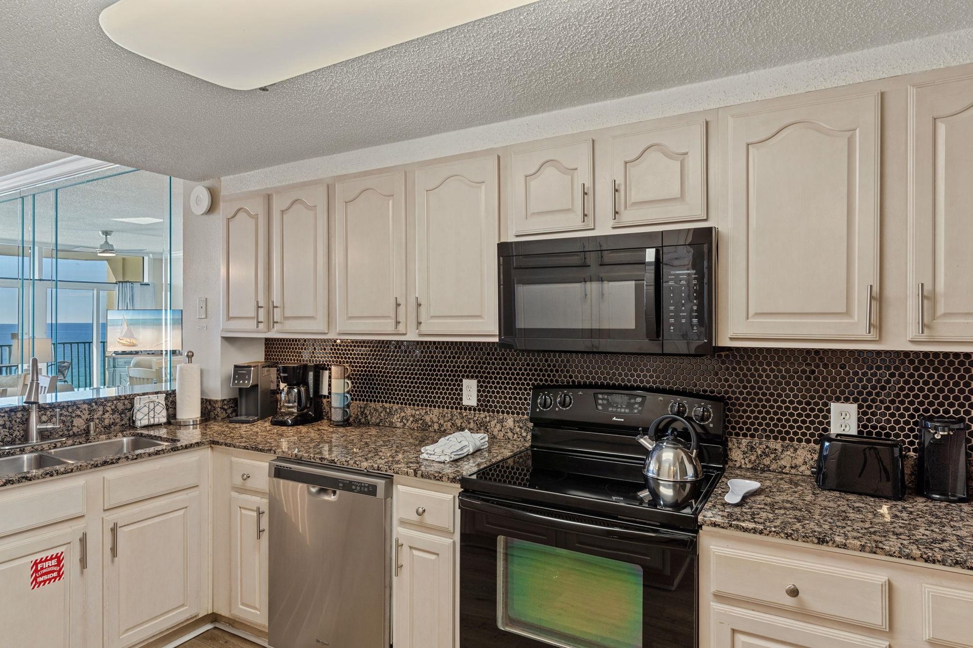 Your fully equipped kitchen features granite counters, stainless appliances, and stunning ocean views.