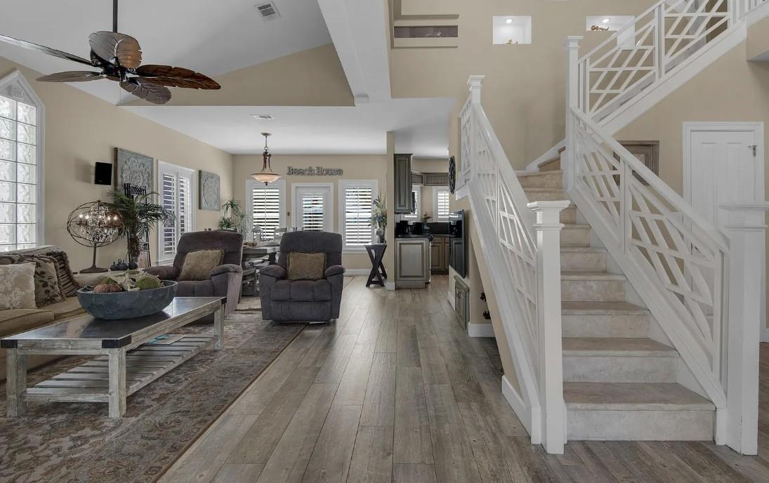 Settle into your spacious openconcept retreat with soaring ceilings, coastal charm, and abundant natural light flowing through your beach house haven.