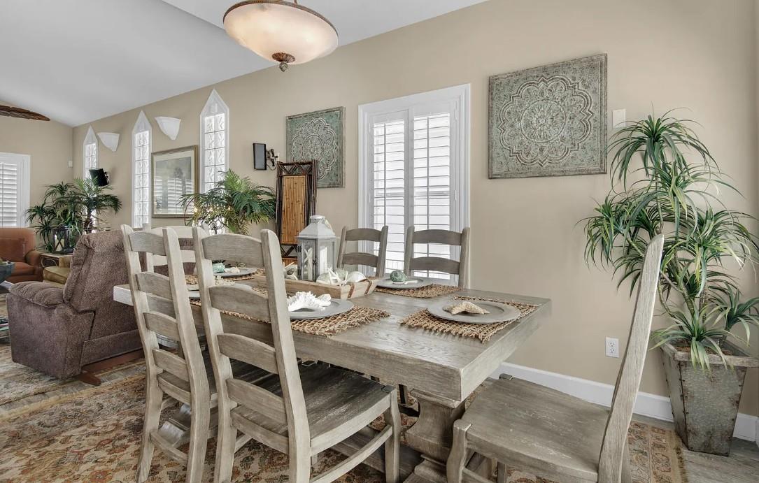 Gather around this rustic farmhouse dining table for memorable meals with loved ones in your bright, plantfilled sanctuary.