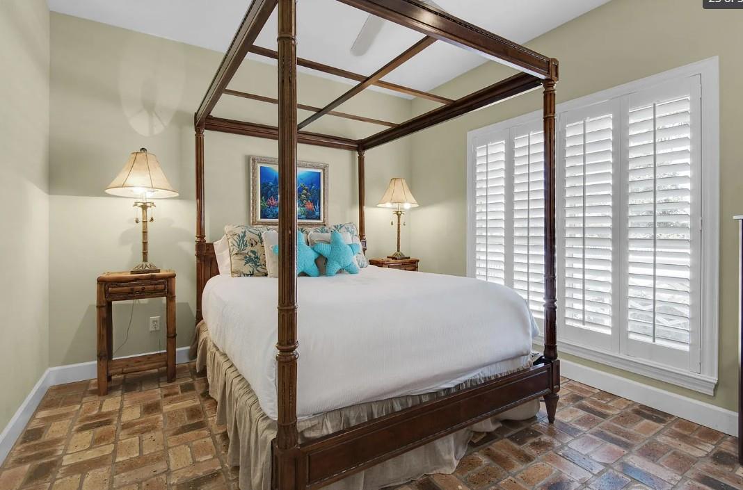 Bedroom 2 Drift into dreams in your elegant fourposter bed, where tropical touches and warm lighting create the perfect sanctuary for rest.