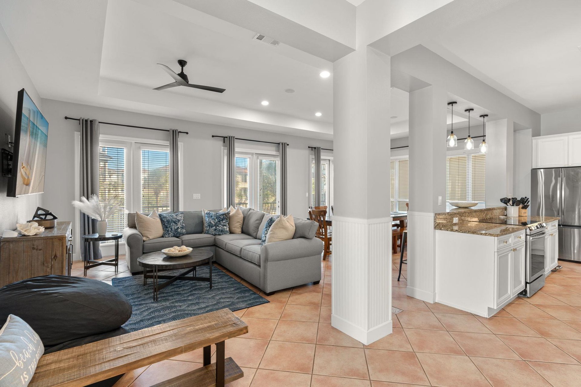 Relax in the spacious openconcept living area where modern comfort meets coastal charm, complete with plush seating and a gourmet kitchen.