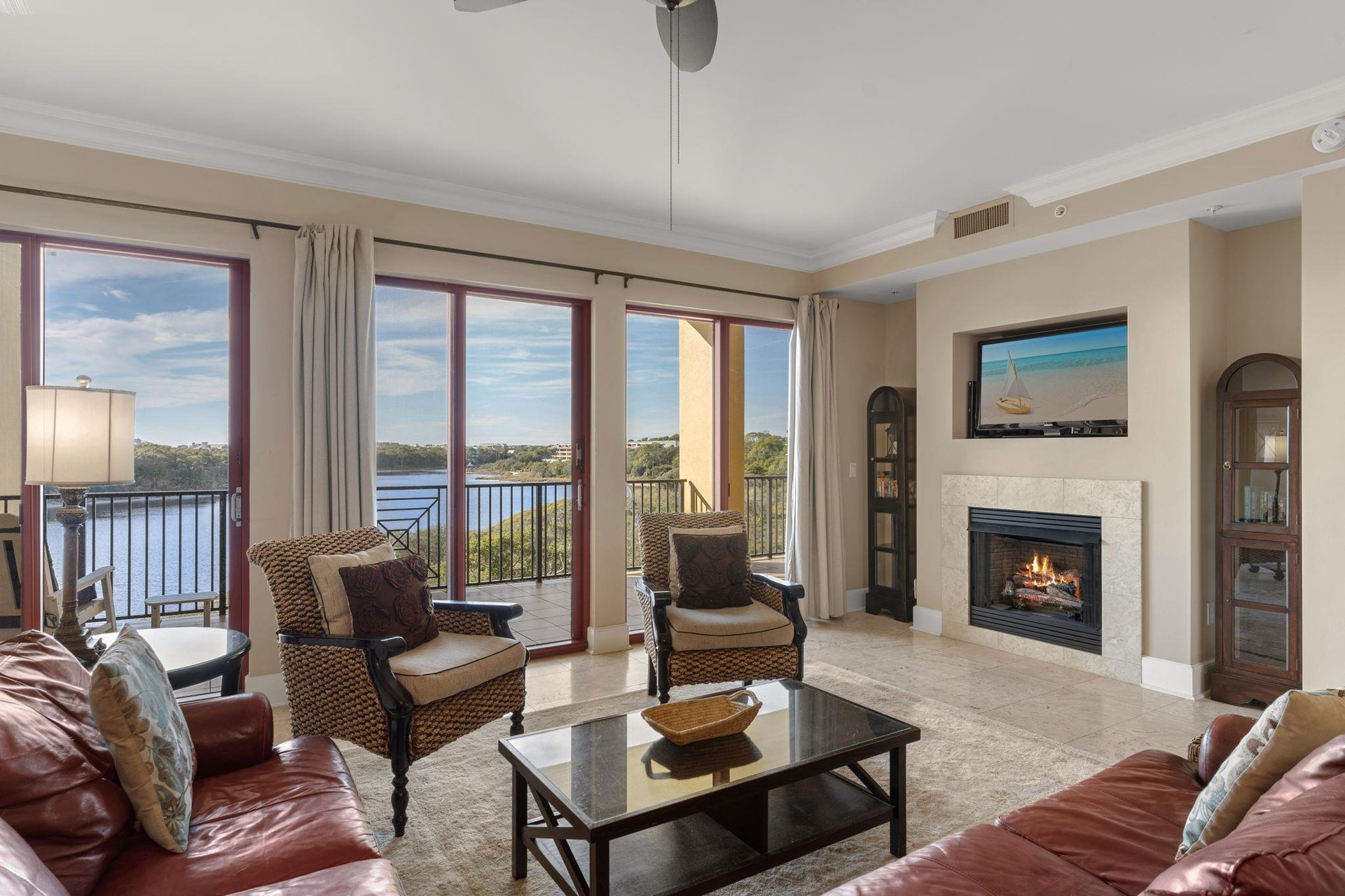 Unwind in your elegant living room where gulf and lake views and a cozy fireplace create the perfect backdrop for relaxation.