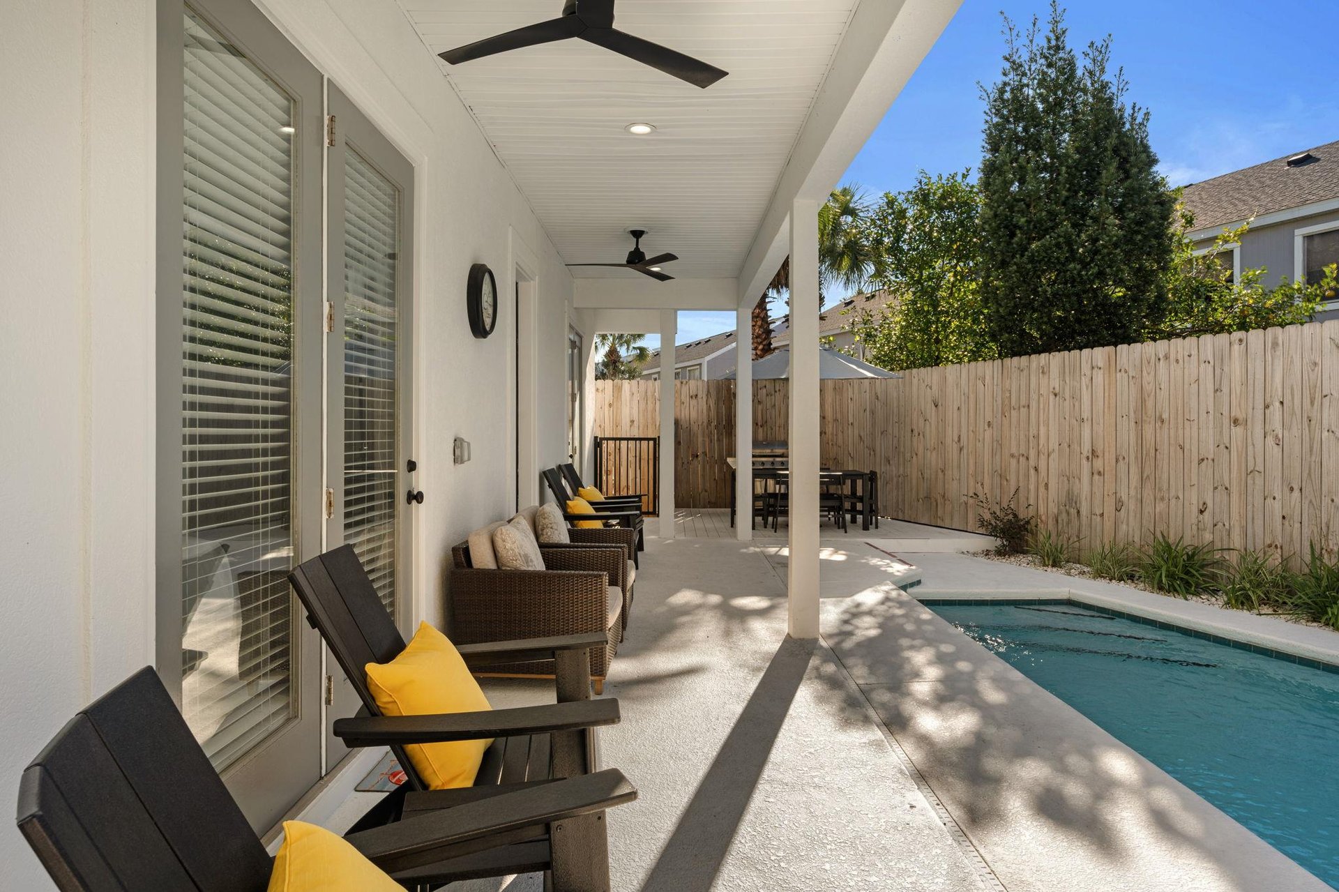 Your private poolside retreat features comfortable seating and ceiling fans for perfect outdoor relaxation.