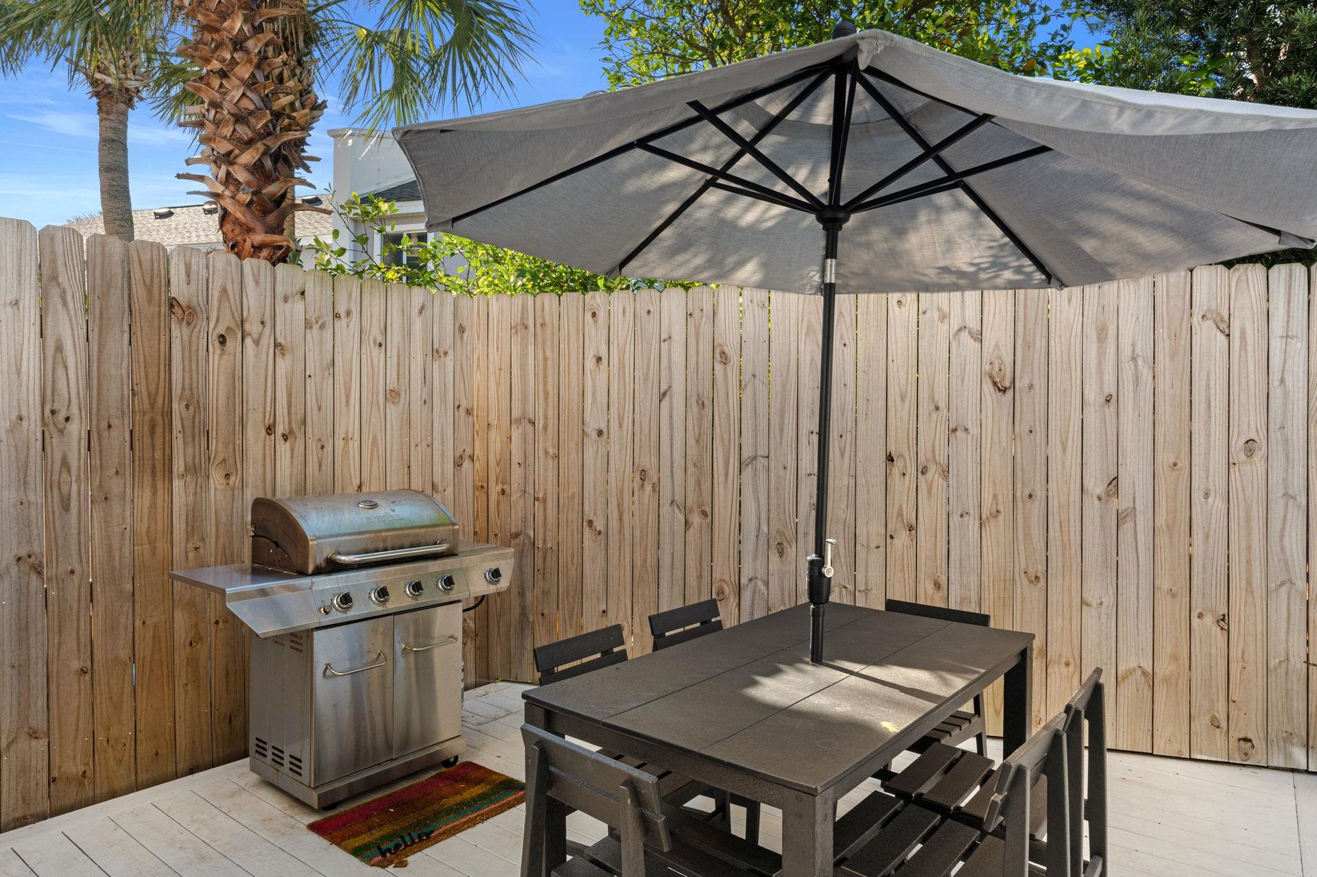 Relax under your private patio umbrella while savoring meals from your dedicated BBQ grill in this peaceful outdoor dining space.