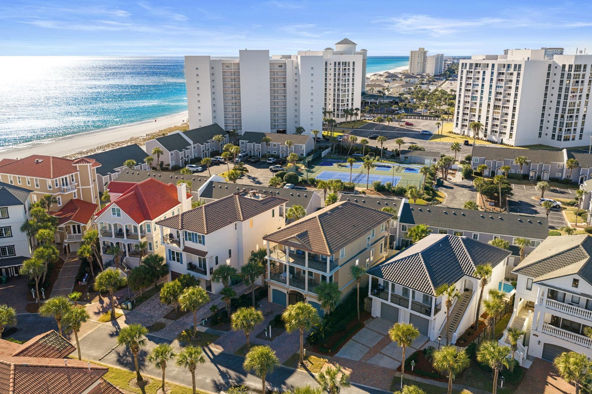 Prime beachfront location with pristine white sand beaches and turquoise waters just steps away from vacation rental properties.