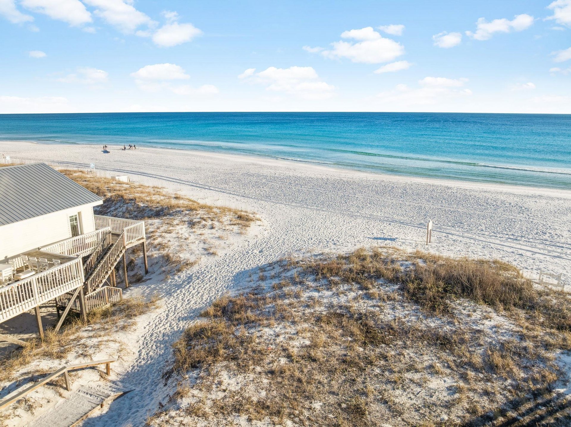 Pristine white sand beach stretches endlessly along turquoise waters, with a dedicated beach access just steps away offering direct access to this coastal paradise.