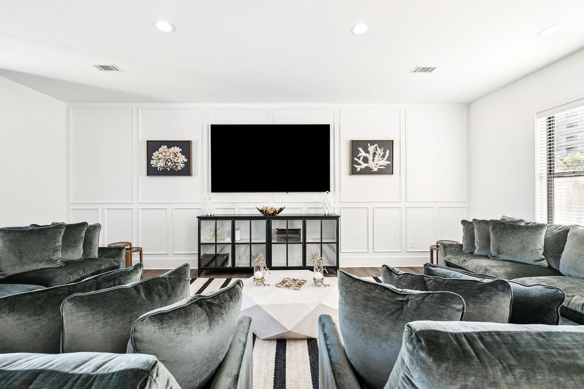 Sink into plush velvet seating while watching your favorite shows on the 100 inch TV in this elegant living space.