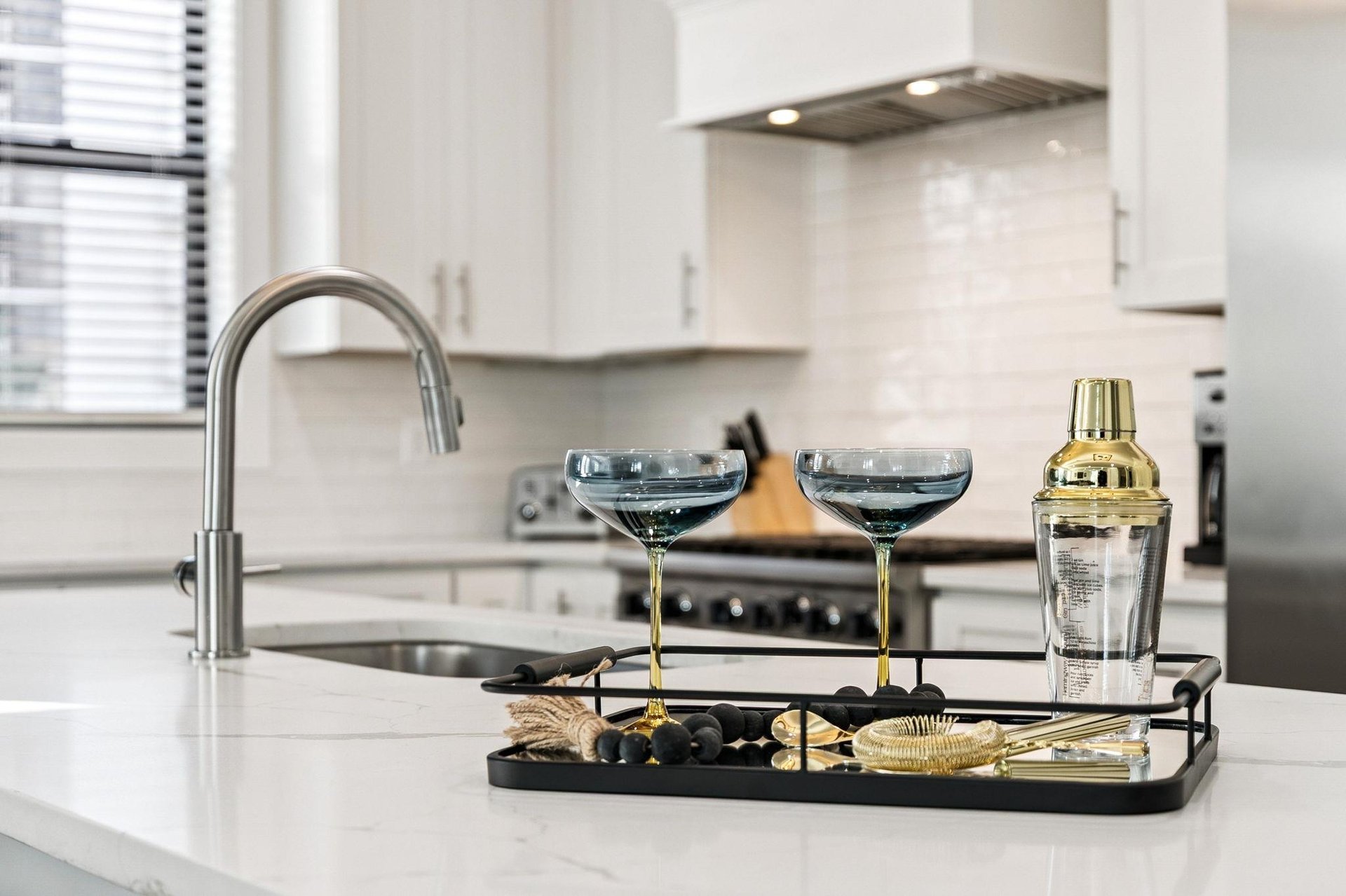 Mix cocktails in the sleek, modern kitchen complete with premium appliances and elegant bar accessories for entertaining.