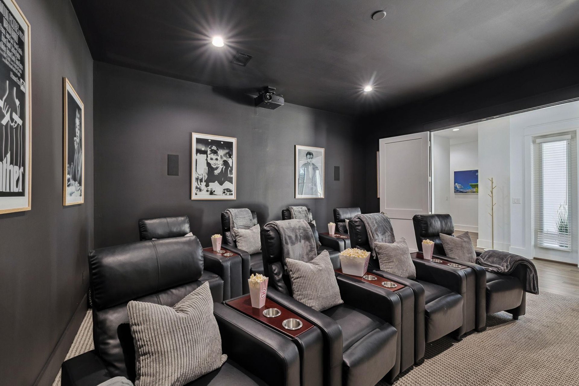 The private theater awaits with plush recliners and perfect lighting for movie nights with family and friends.