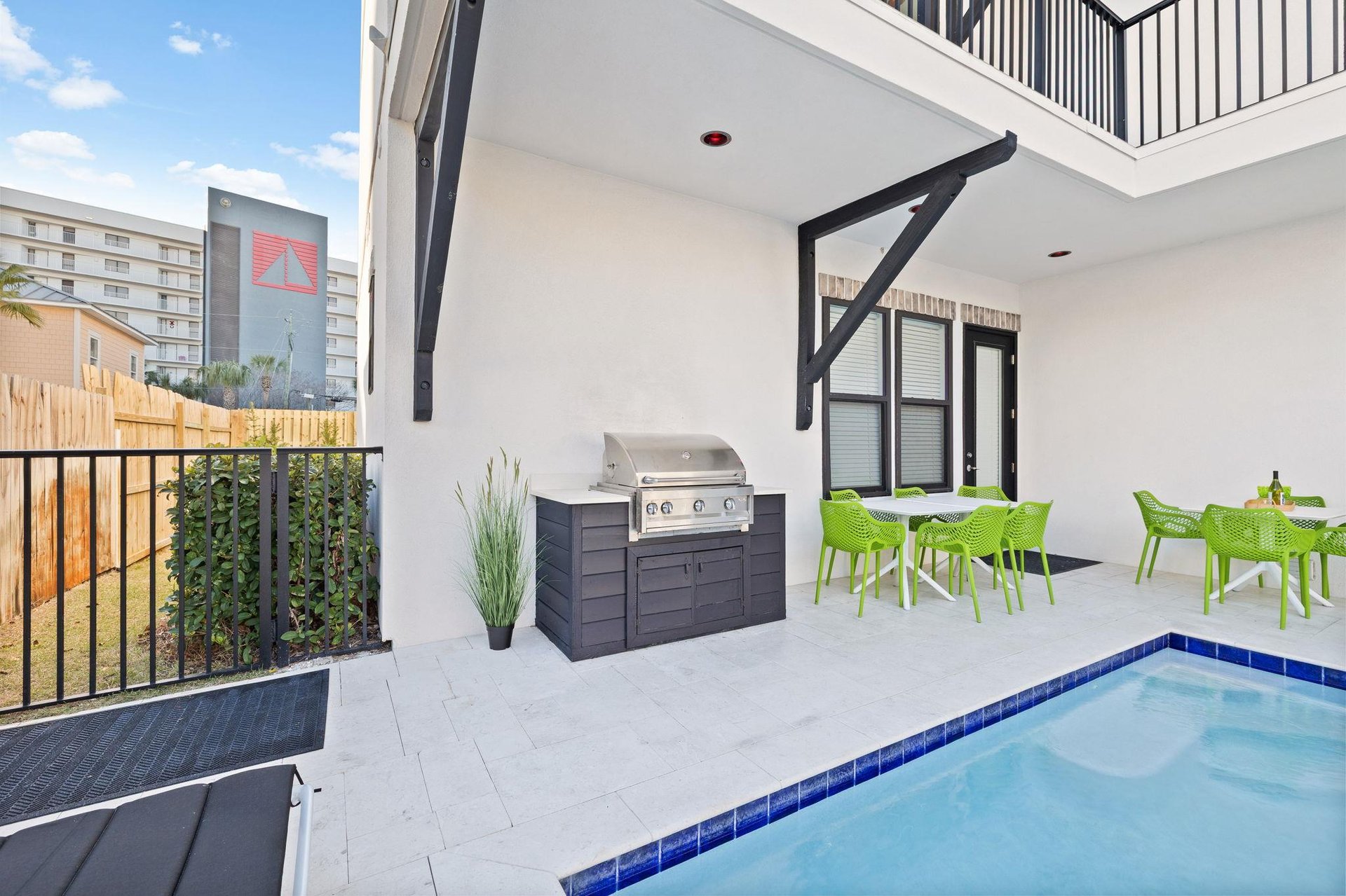 The private patio oasis features a sparkling pool and BBQ setup perfect for al fresco dining.