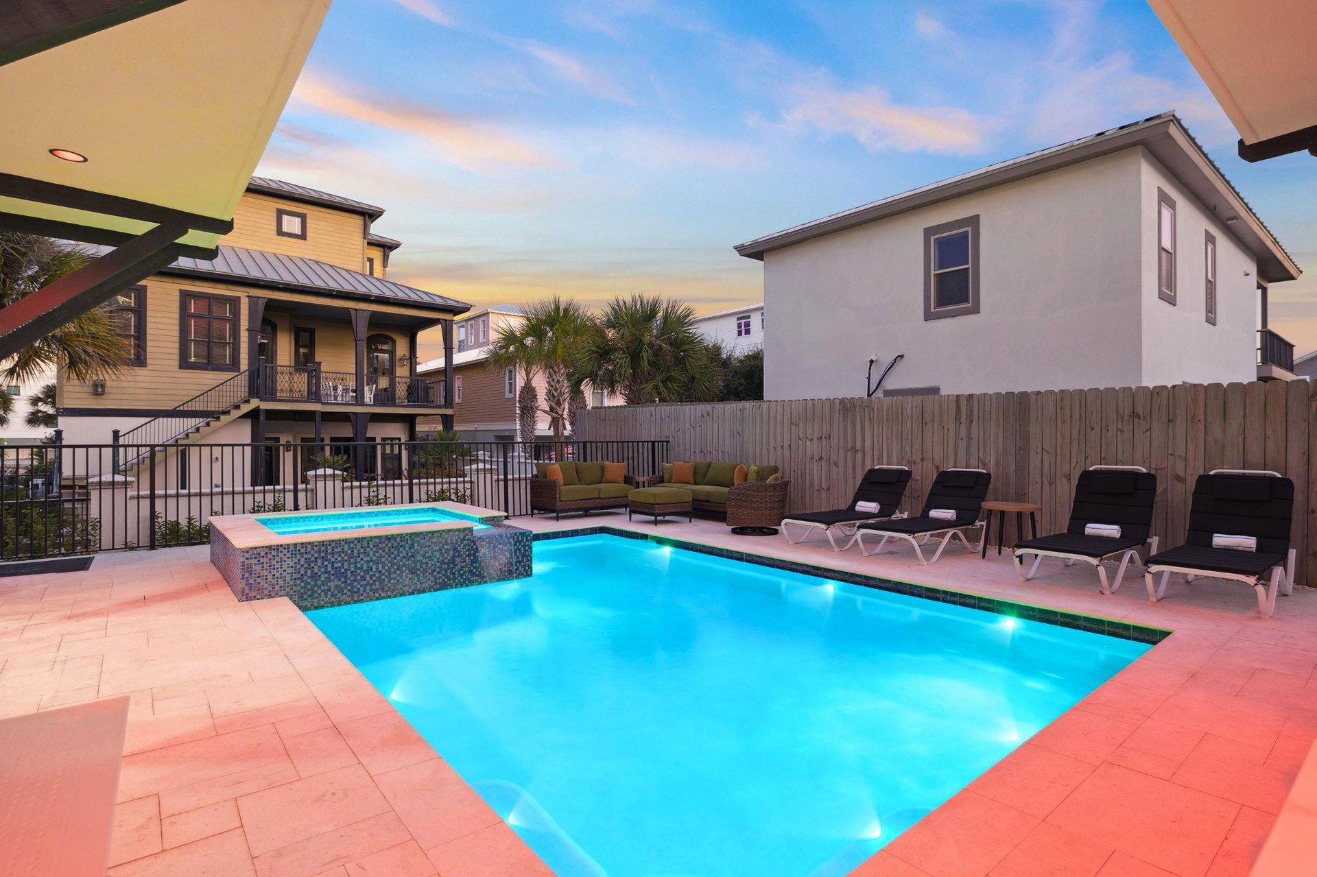 Dive into the private pool where turquoise waters meet comfortable loungers under painted evening skies.