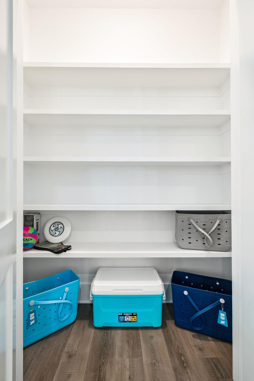 Your organized storage closet keeps beach gear and coolers perfectly arranged for spontaneous adventures.