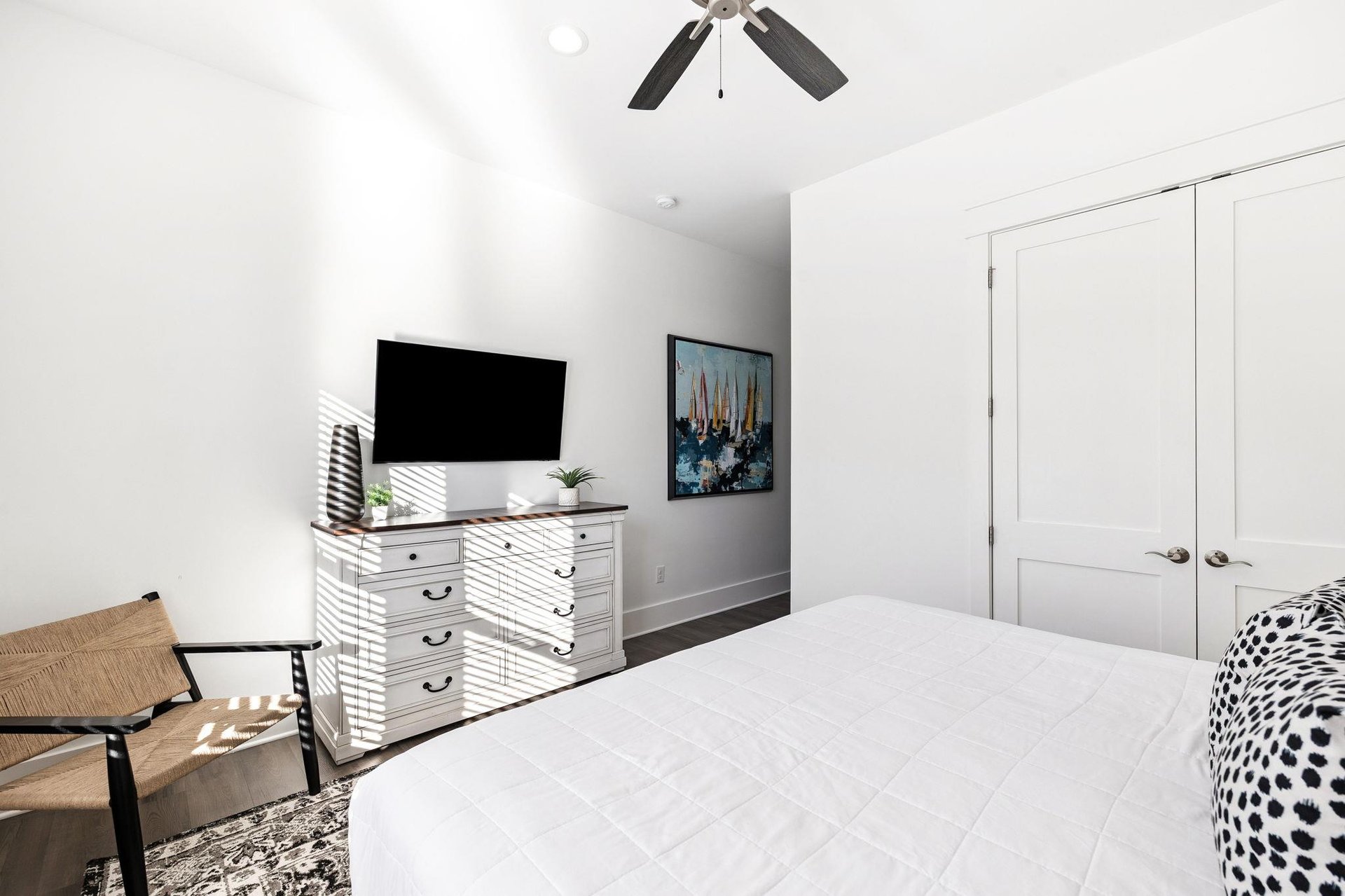 Your bright bedroom features a comfortable bed, flatscreen TV, and stylish furnishings for a restful stay.