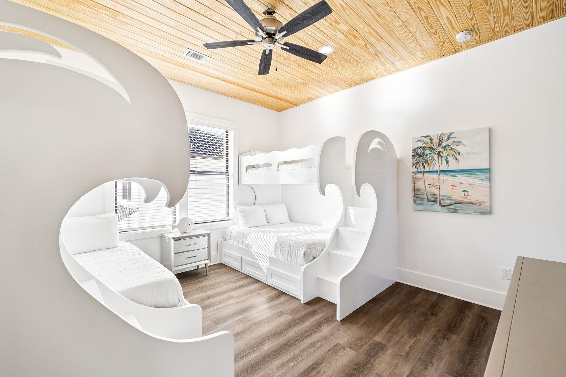 Step into your dreamy bedroom featuring custom curved walls and warm wood ceiling fan keeping you cool during peaceful nights.