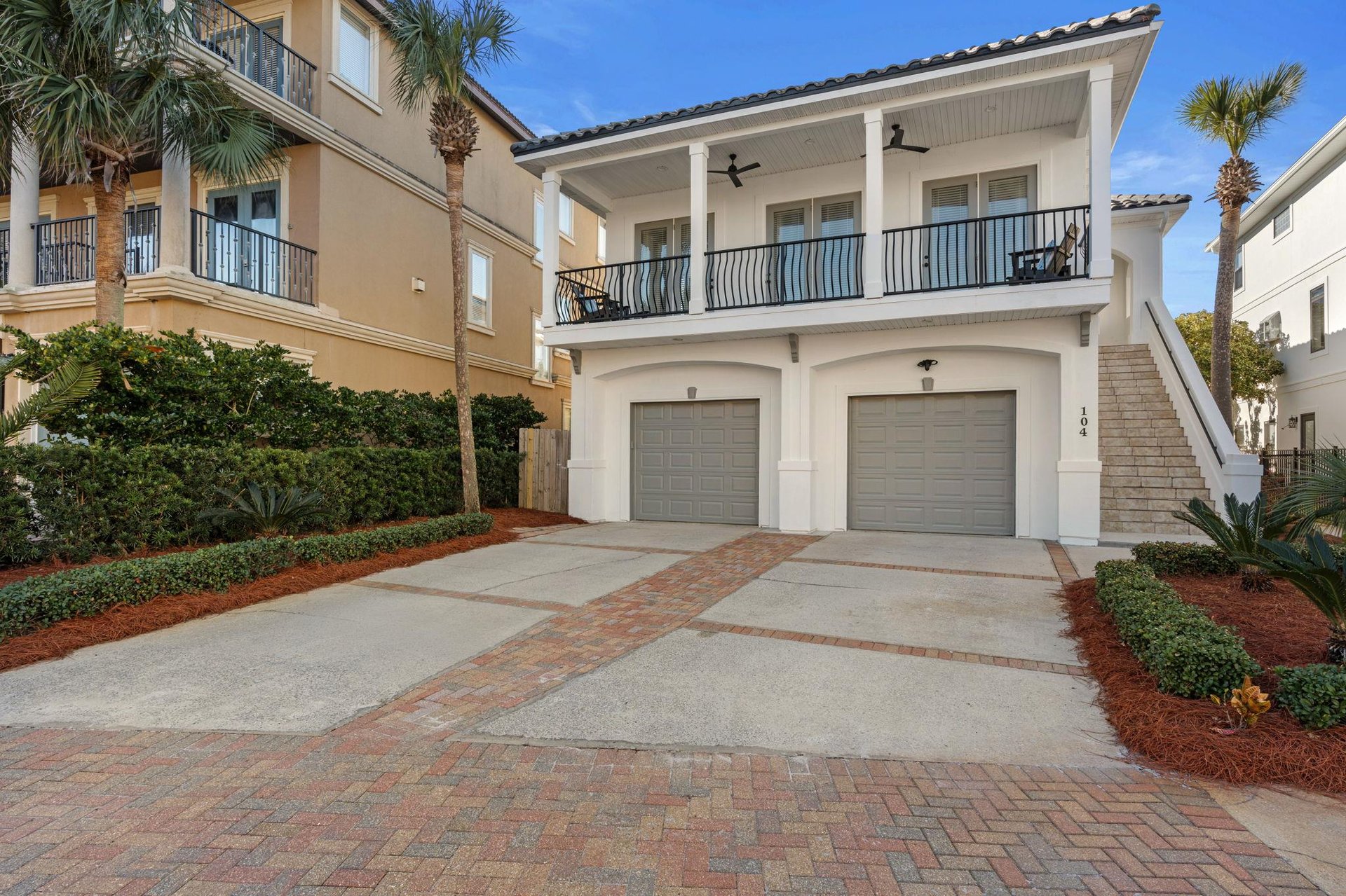 Twostory coastal home featuring a spacious covered balcony and convenient twocar garage in the beautifully landscaped neighborhood of Dunes of Destin