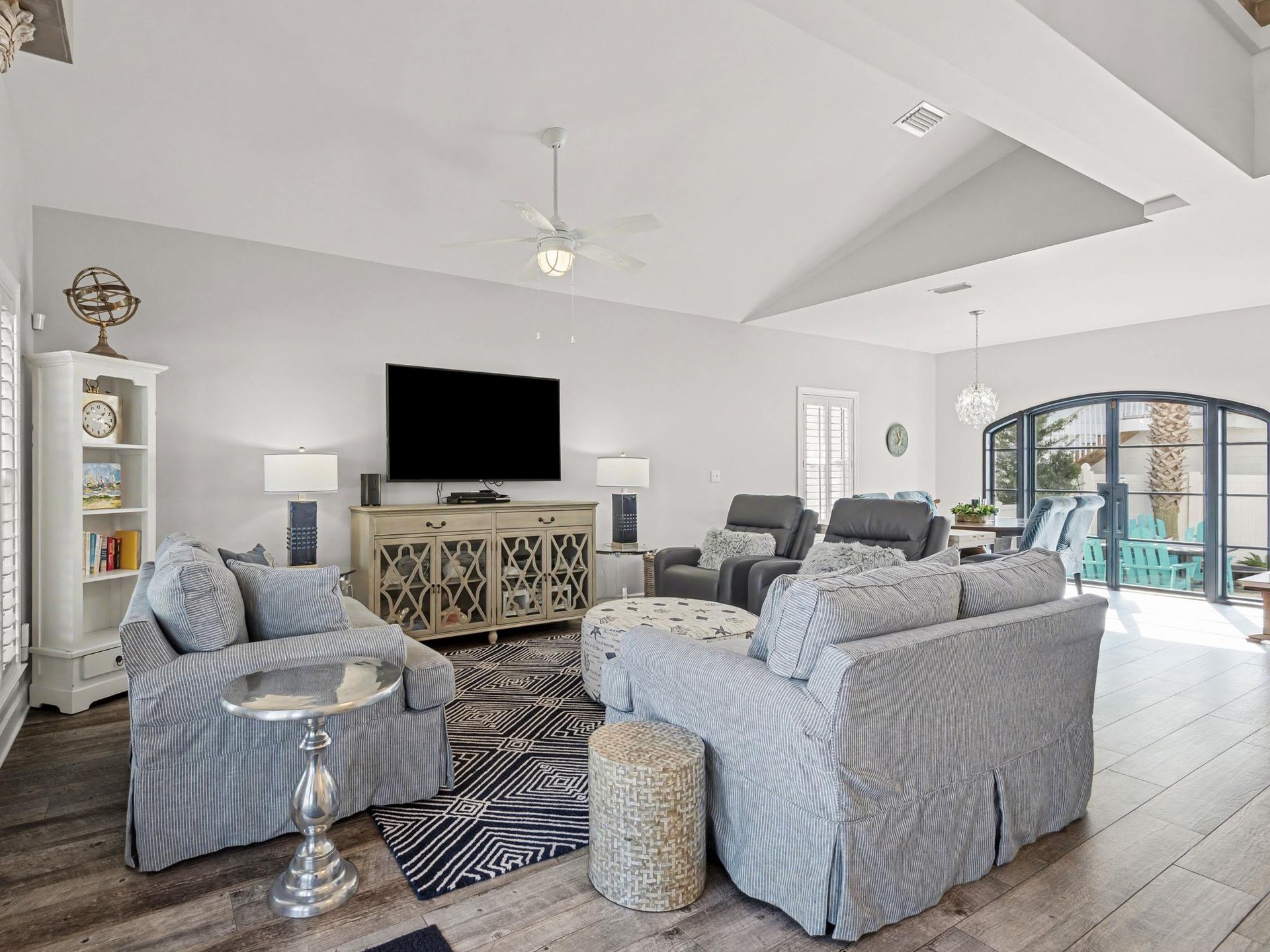 Sink into plush sofas in your spacious living room, where high ceilings and elegant decor create the perfect atmosphere for relaxation.