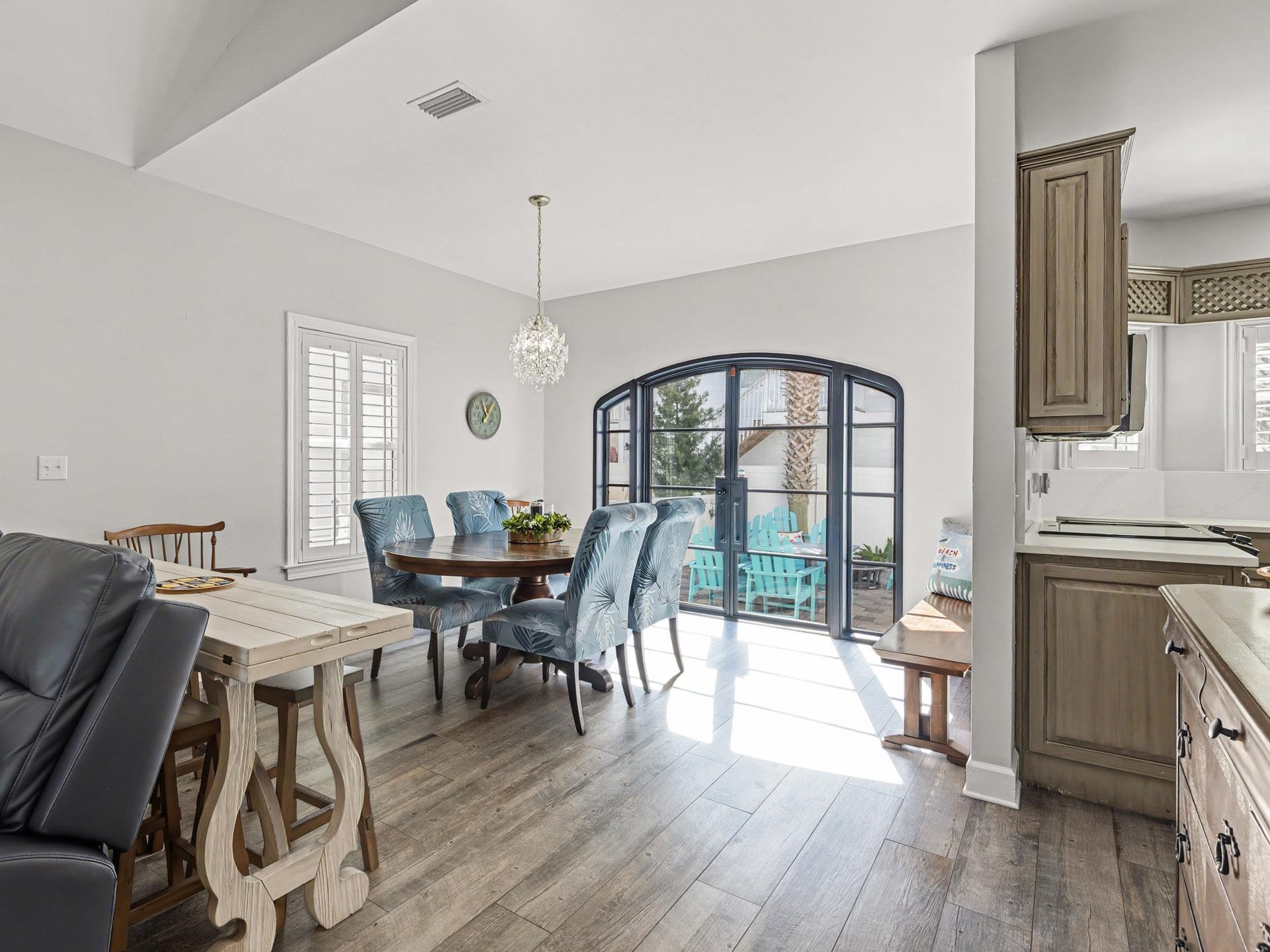 Your elegant dining space flows seamlessly to the patio through stunning arched French doors, perfect for morning coffee or sunset dinners.