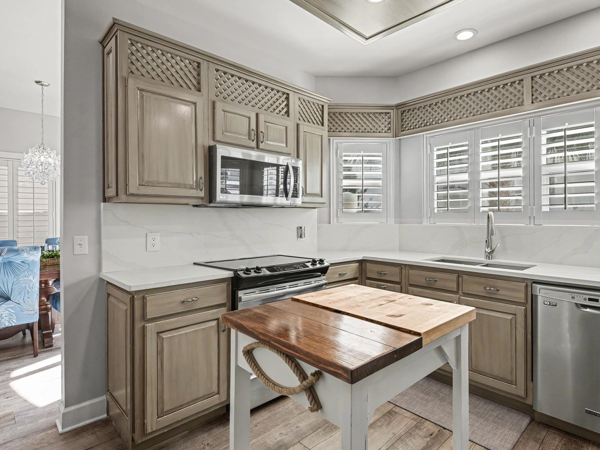 Your beautiful kitchen features elegant cabinetry, marble countertops, and modern appliances, perfect for preparing meals during your stay.