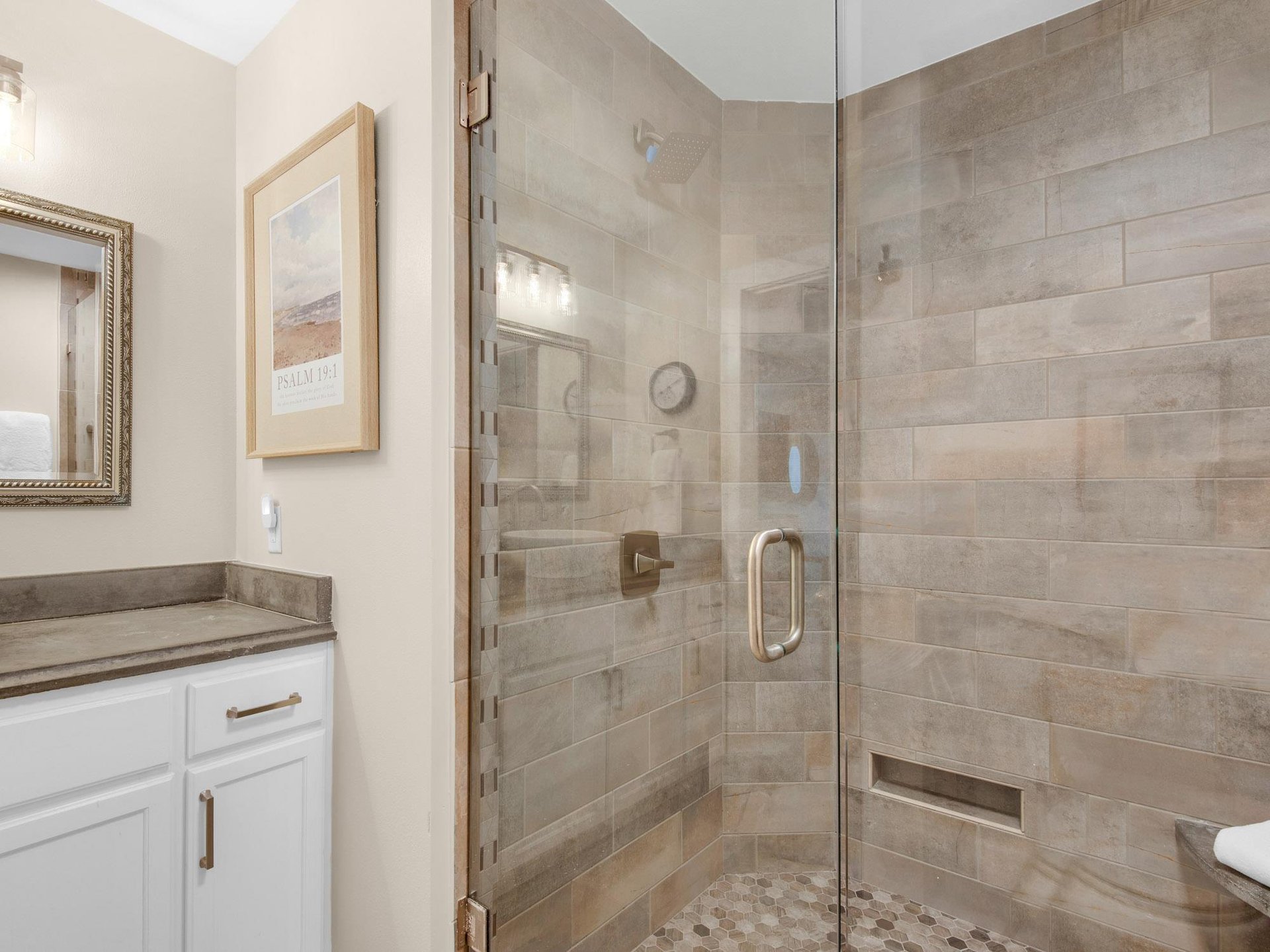 Step into your luxurious tiled shower with glass doors, offering a spalike retreat for refreshing mornings and relaxing evenings.