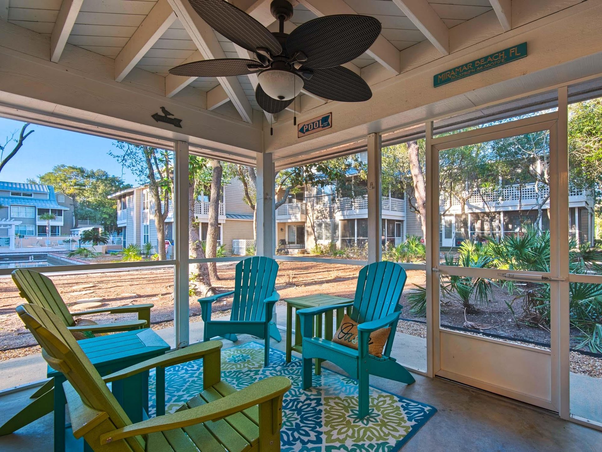Relax in your screened porch with colorful Adirondack chairs and tropical garden views. The ceiling fan keeps you comfortable yearround.