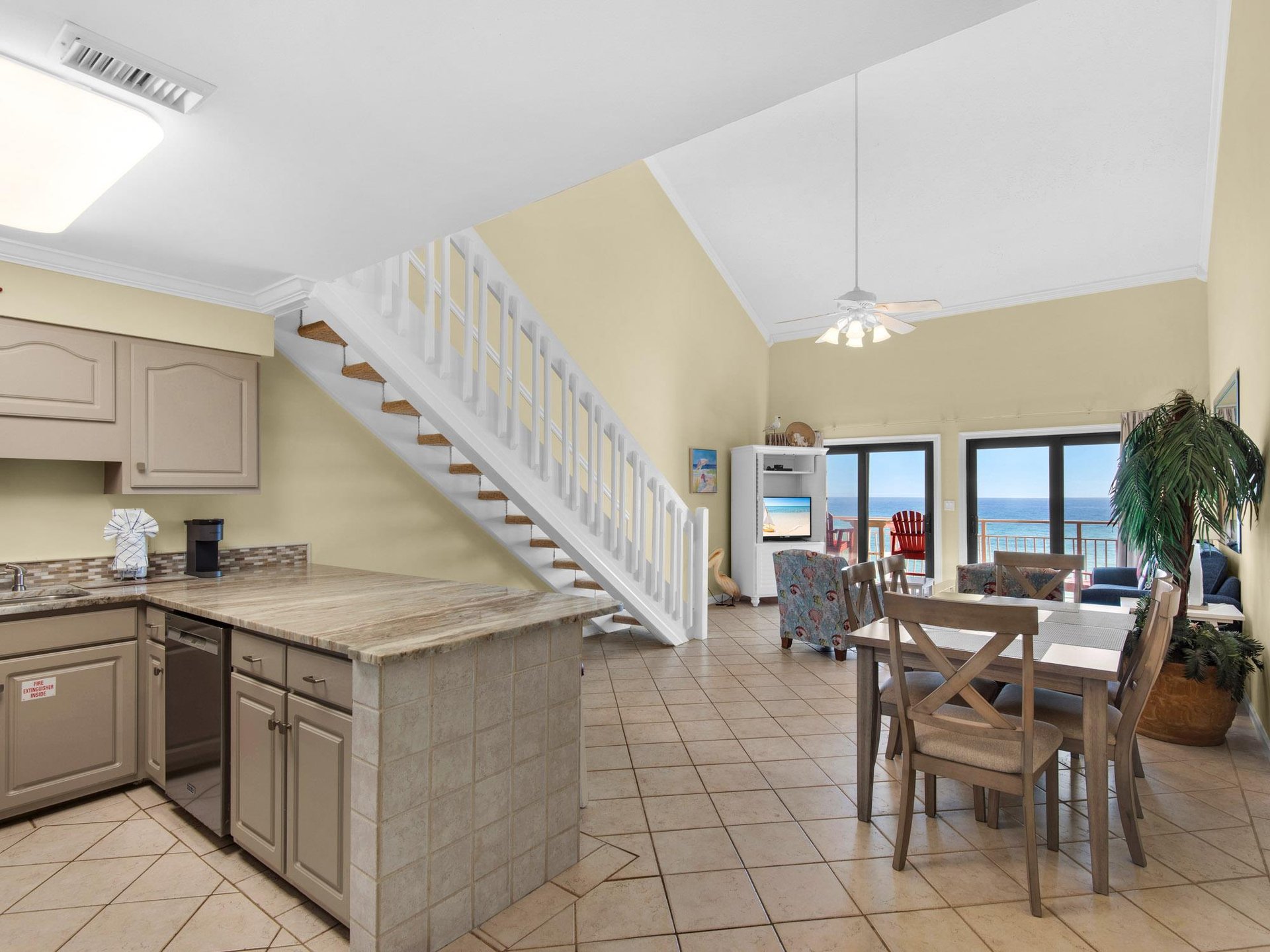 Openconcept living space where you can cook, dine, and relax while enjoying stunning ocean views through sliding glass doors.