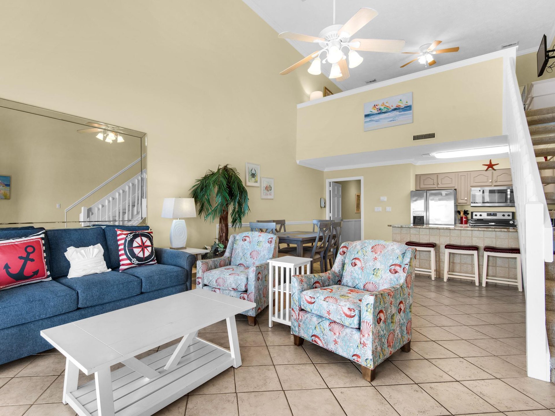 Relax in your coastalthemed living space with cozy seating, coastal decor, and open kitchen—perfect for beachside getaways.