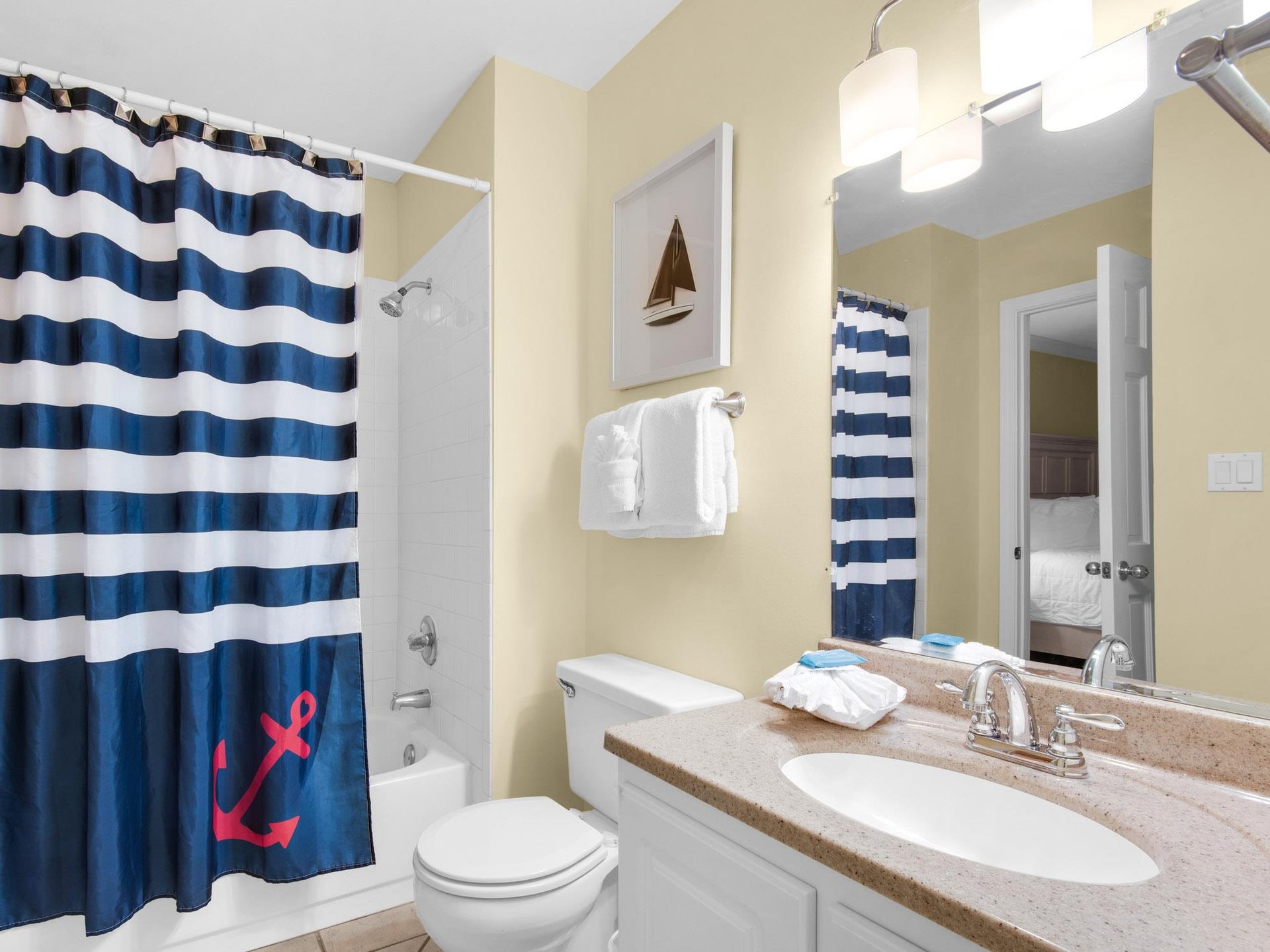 Your private bathroom features a relaxing tubshower combo with nautical charm, plus soft towels and coastal décor for your comfort.