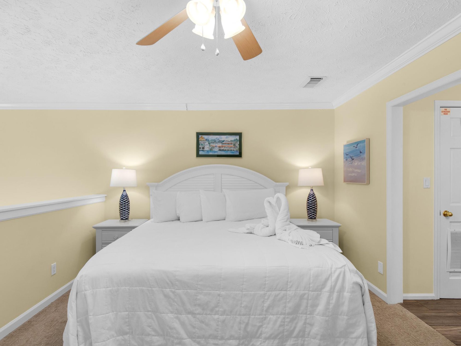 Your peaceful retreat awaits with crisp white linens, gentle bedside lighting, and a ceiling fan to keep you comfortable.
