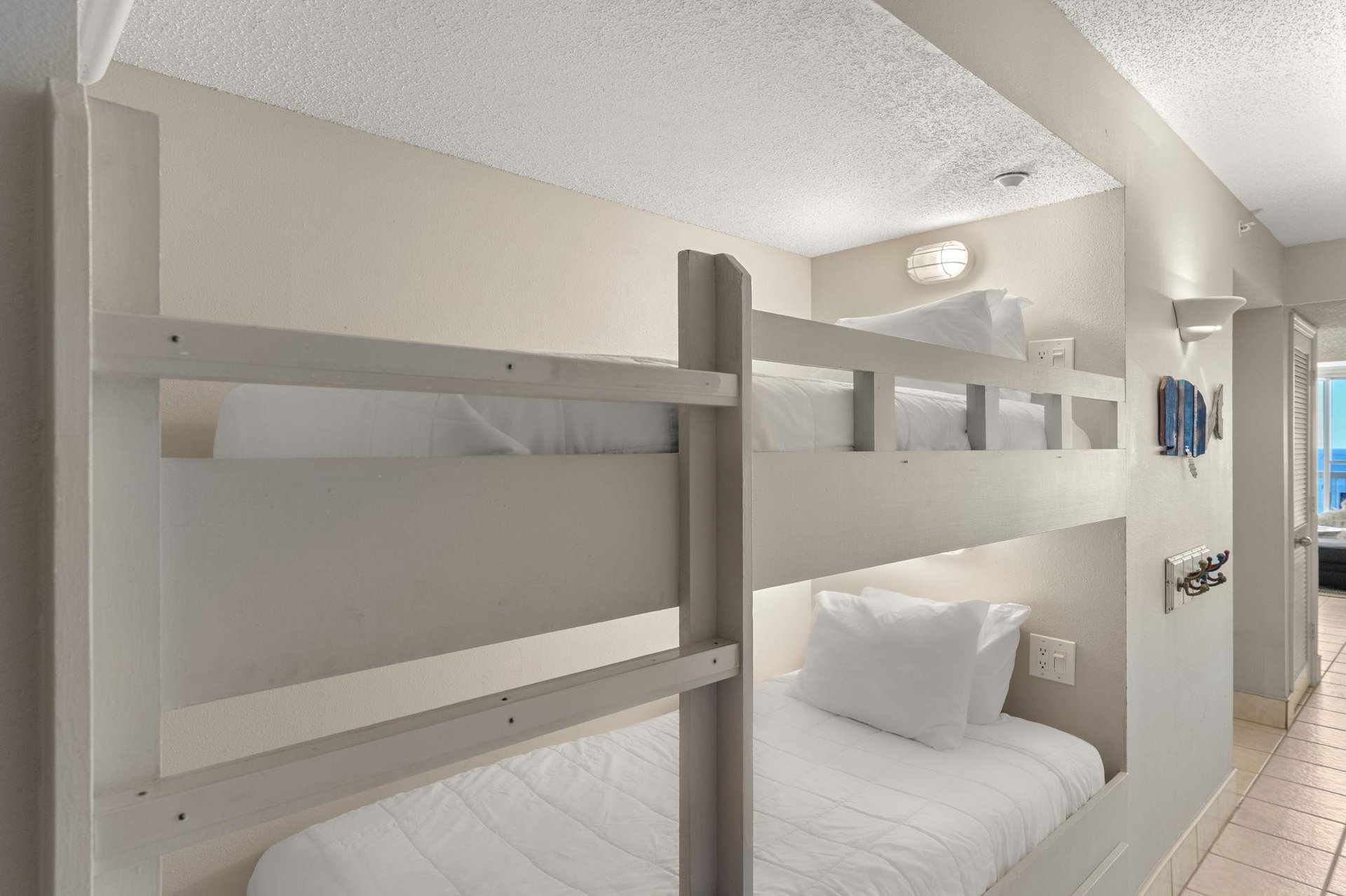 The bunk area features comfortable builtin beds with crisp linens and personal reading lights for a cozy nights sleep.