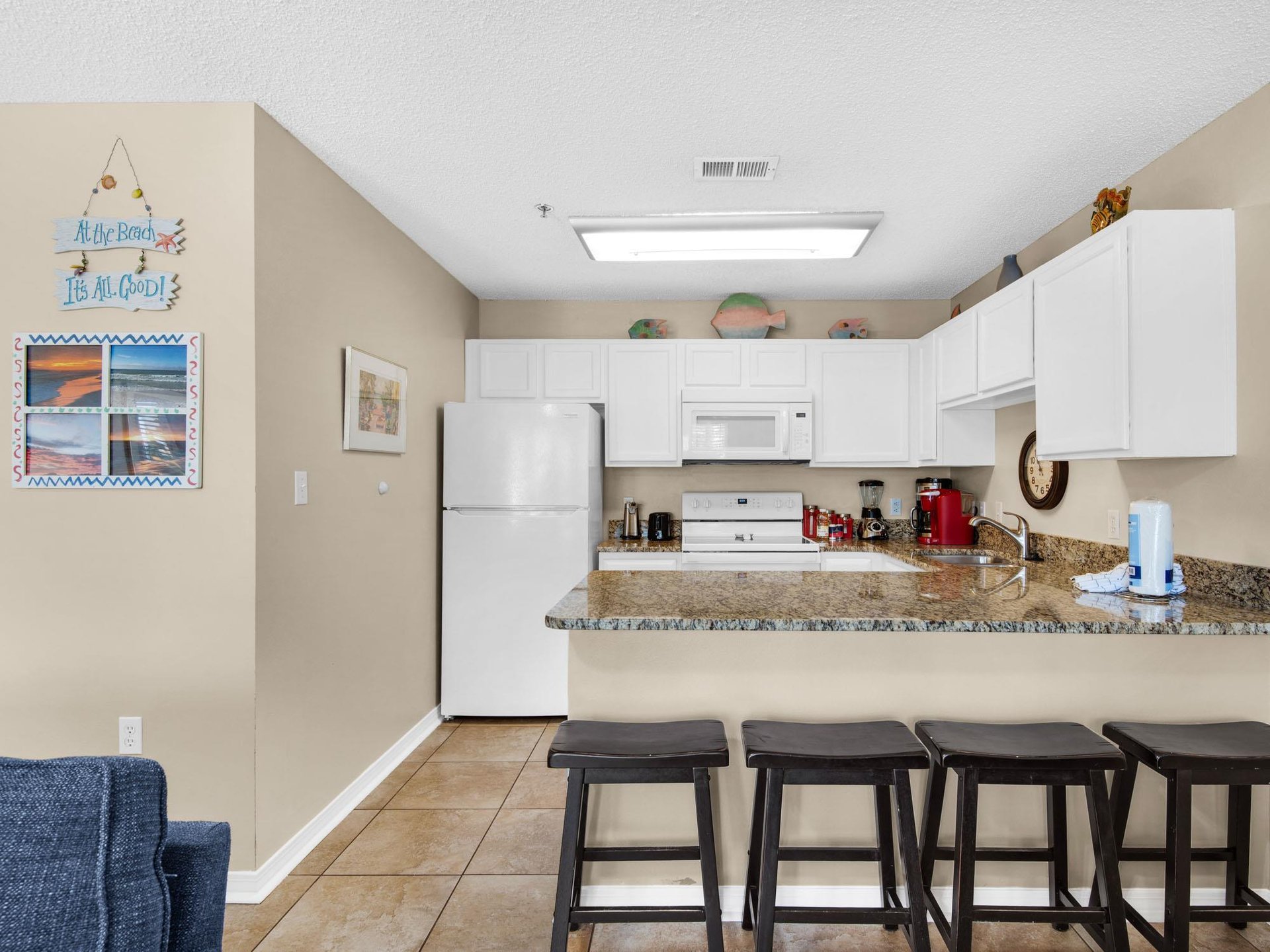 Cook with ease in the fully equipped kitchen featuring breakfast bar seating for casual dining.