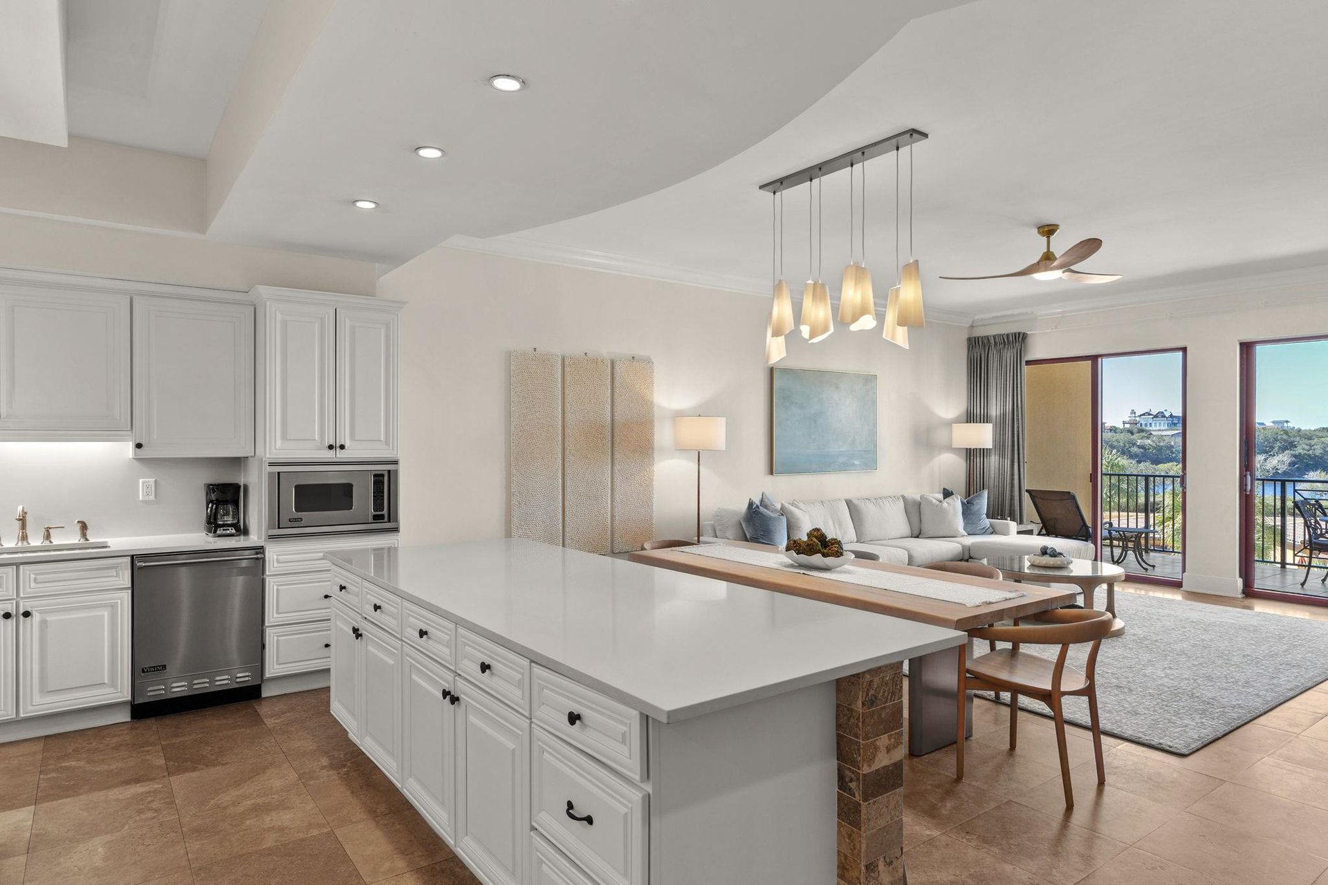 Your spacious openconcept retreat blends modern comfort with elegant design, where sleek white cabinetry meets warm wood accents and stunning lake views.