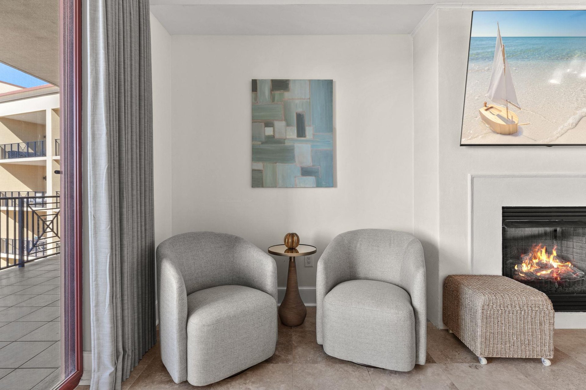 Unwind in your private seating area where modern comfort meets coastal charm, complete with a cozy fireplace for perfect evening relaxation.