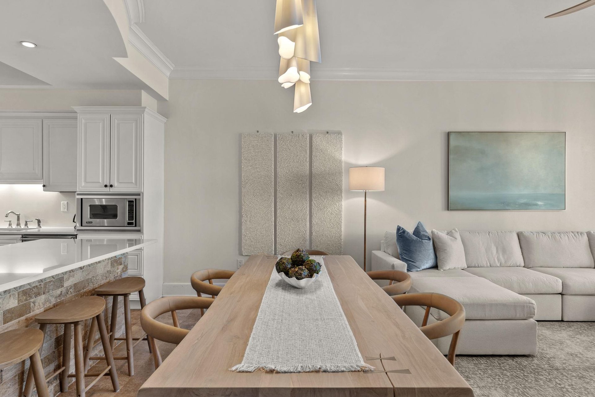 Settle into your openconcept haven where modern coastal style meets comfort. Gather around the dining table or sink into plush seating.