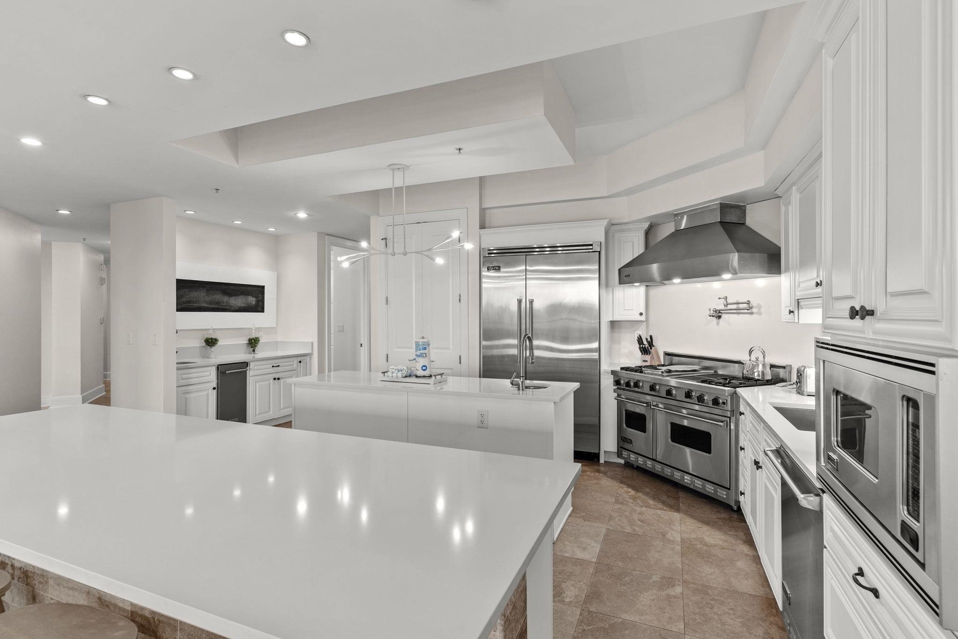 Your dream kitchen awaits with pristine marble countertops, professionalgrade appliances, and bright white cabinetry perfect for creating memorable meals.