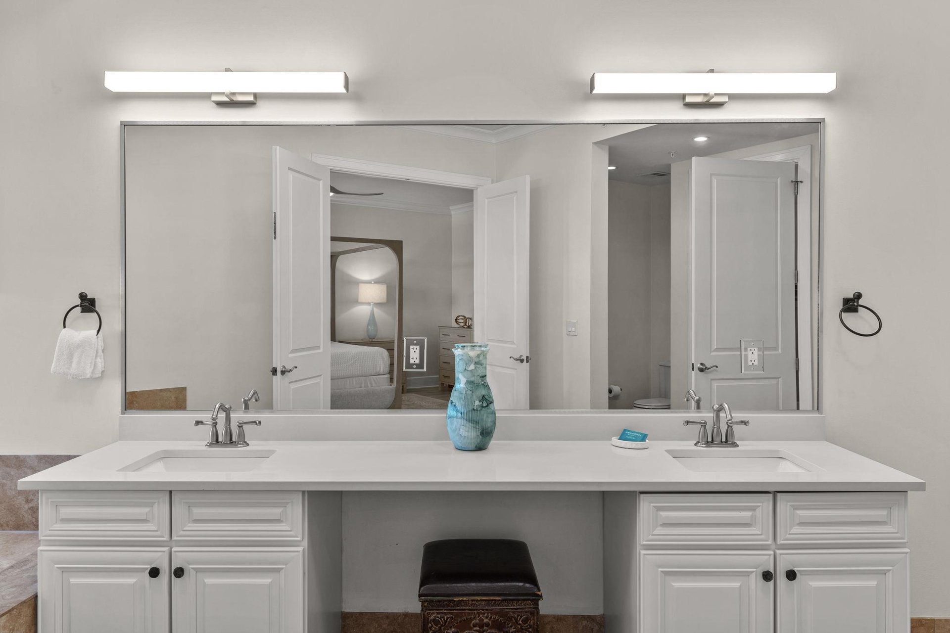 Your spacious double vanity offers plenty of room for two, with elegant lighting and modern fixtures for your morning routine.