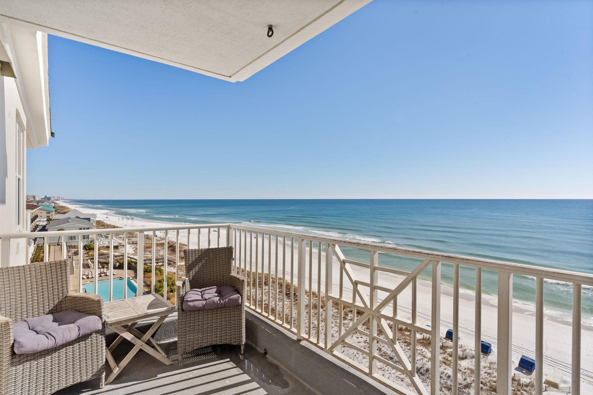 The private balcony has stunning gulf views and comfortable seating.