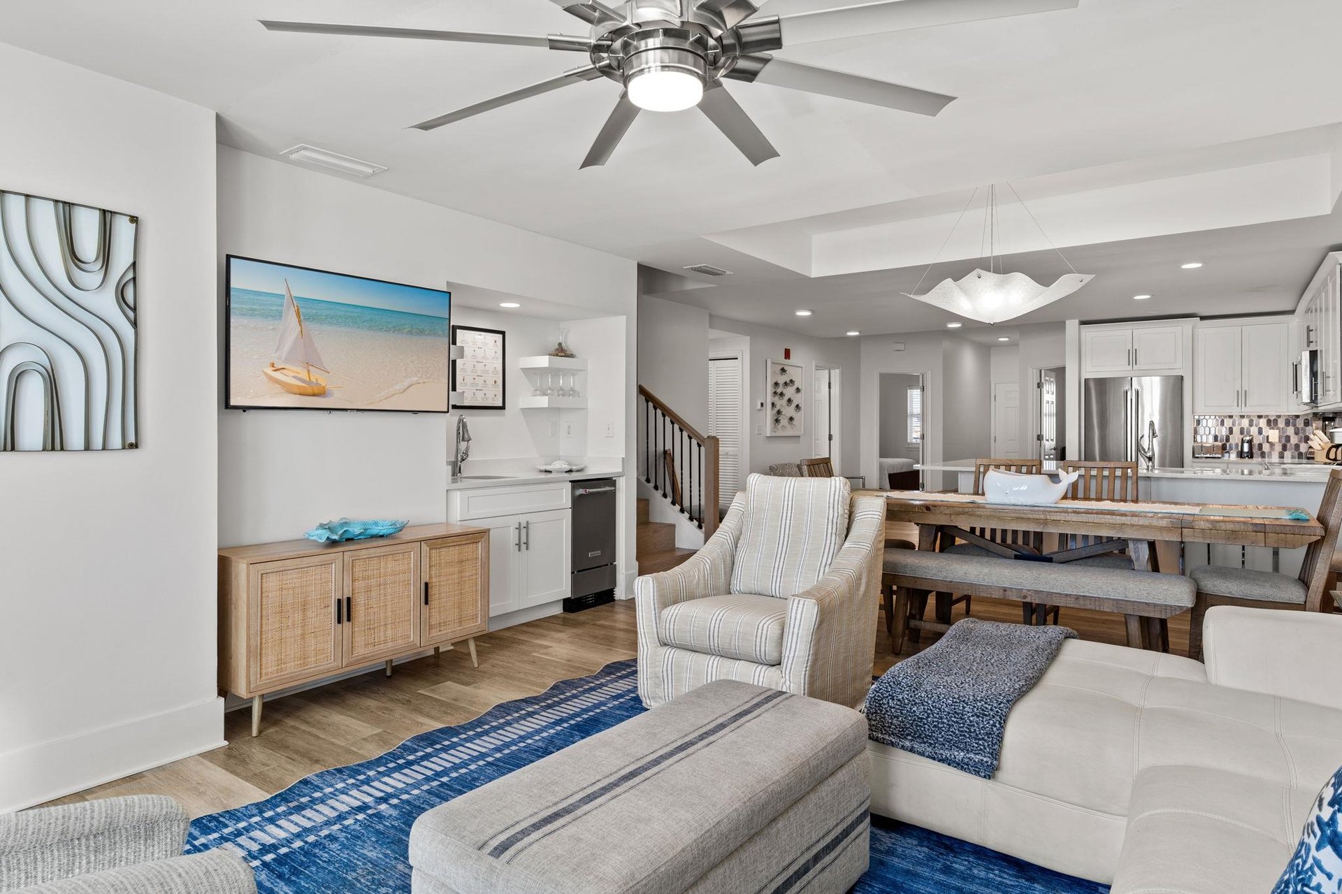 Coastal charm, complete with ceiling fan and modern kitchen.