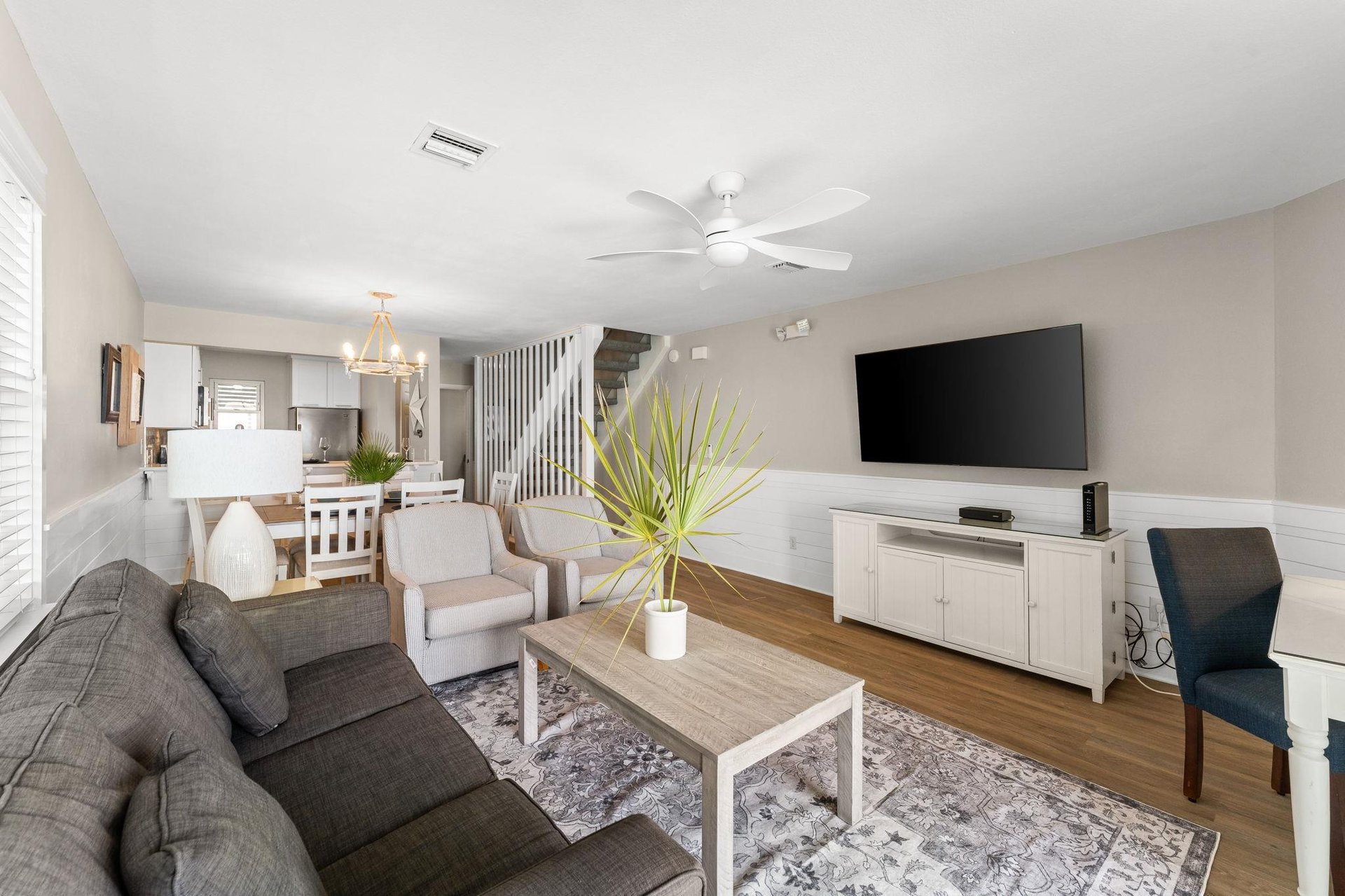 Modern living room with stylish furnishings and mounted flat screen smart TV