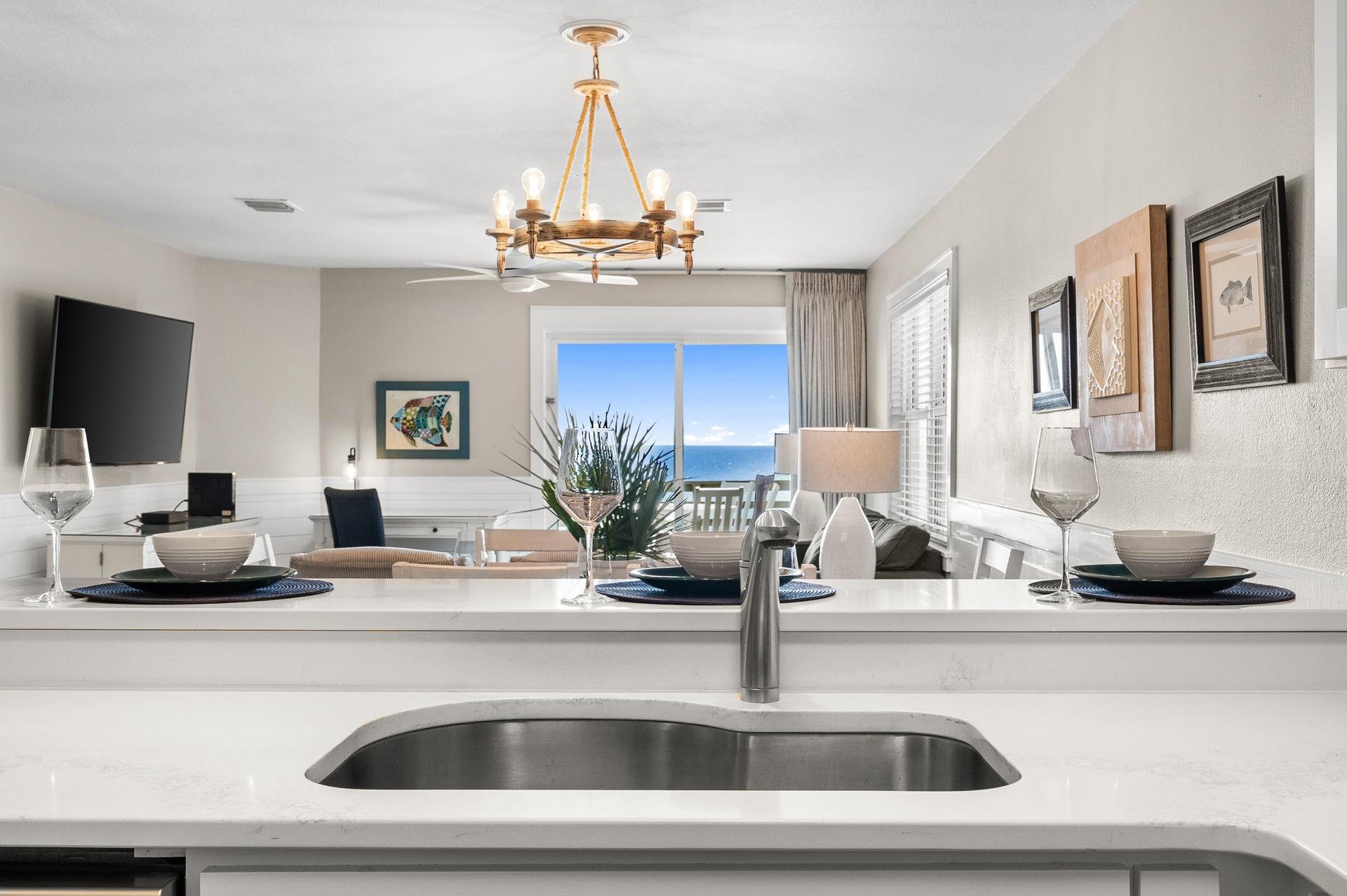 The elegant kitchen island is the perfect gathering spot, with stunning Gulf views creating a backdrop for memorable meals and conversations.