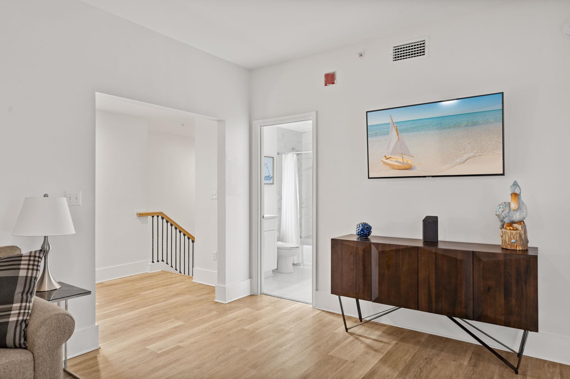 Coastal artwork and modern furnishings create a perfect retreat atmosphere.