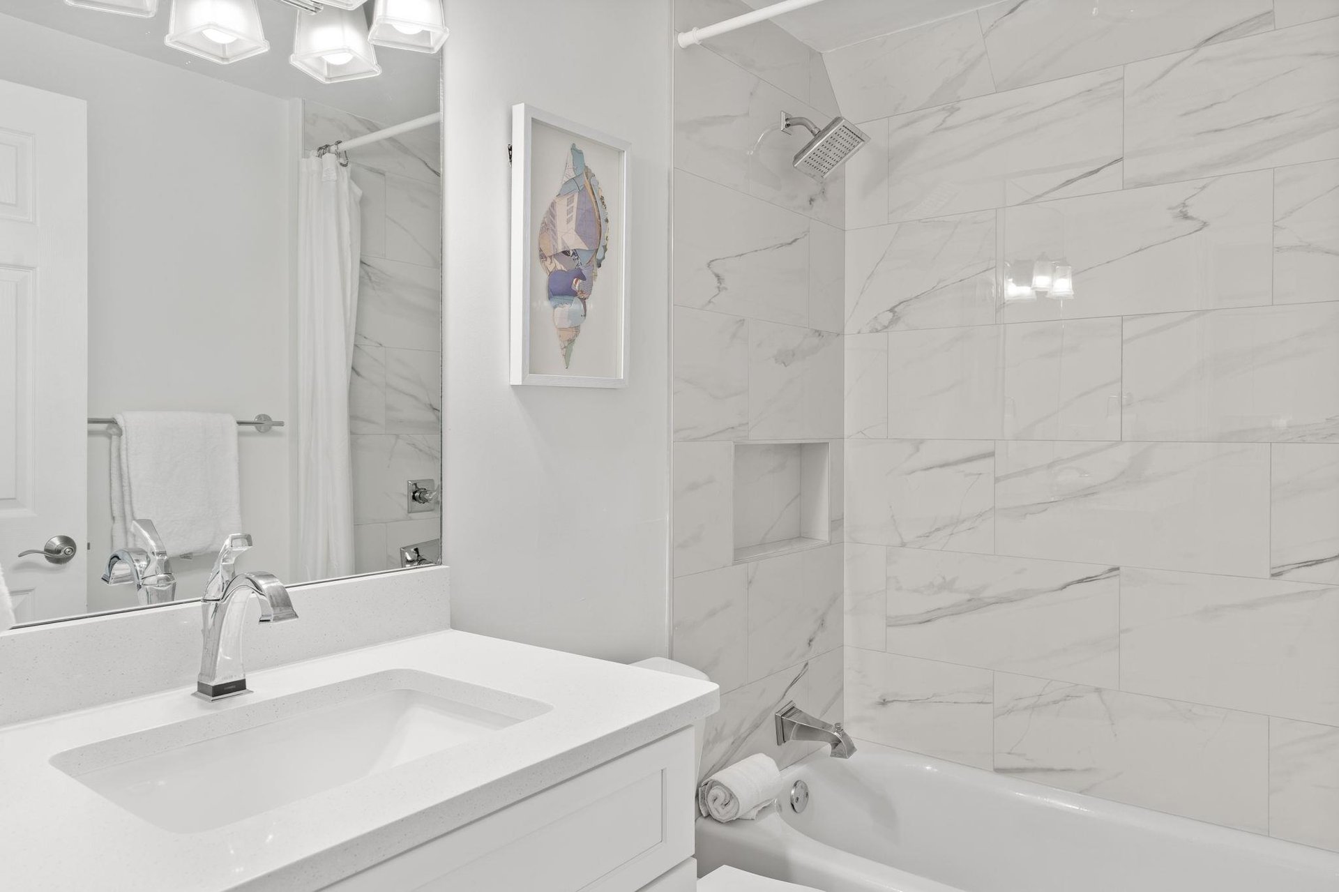 This marble bathroom features a luxurious soaking tub and shower combo.