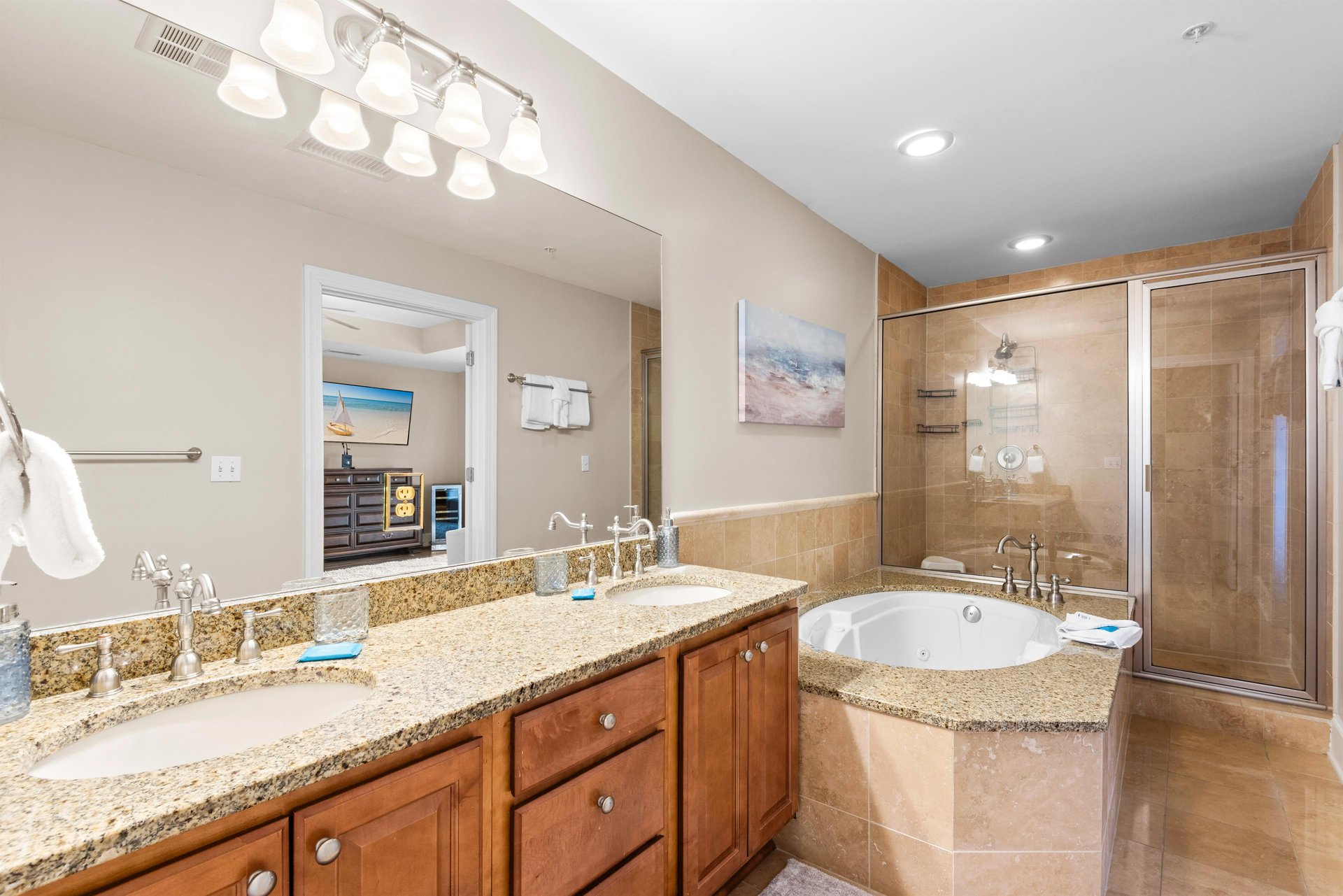 Unwind in the luxurious ensuite featuring a soaking tub, granite countertops, and elegant tile finishes—your personal spa retreat after a long beach day.