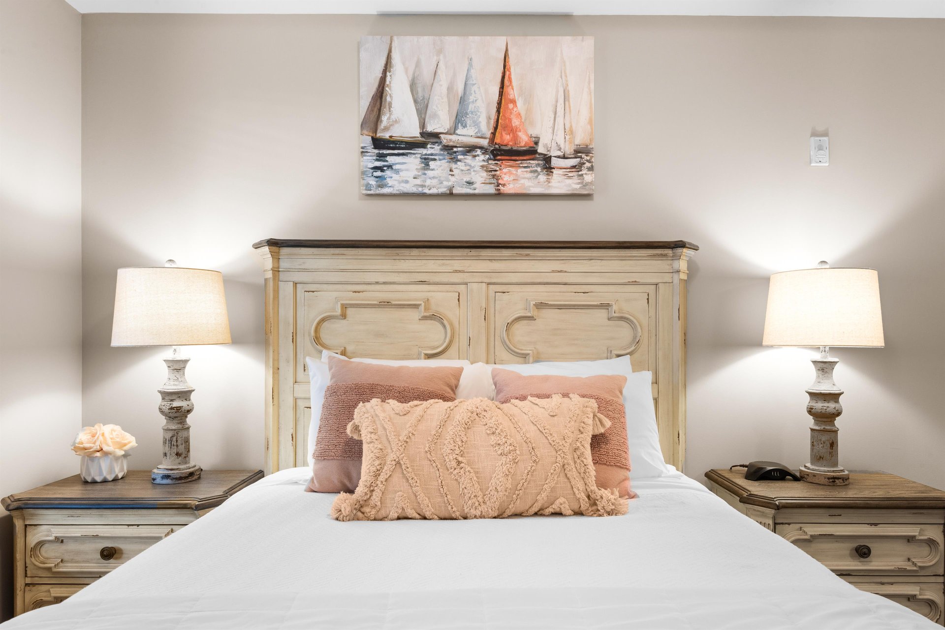 Sink into this coastalinspired bedroom where warm textures and nautical artwork create your perfect seaside retreat.
