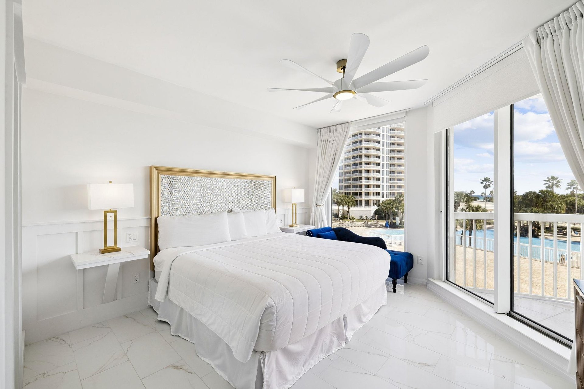Wake up to stunning waterfront views in your bright, elegant bedroom with pool access steps away.