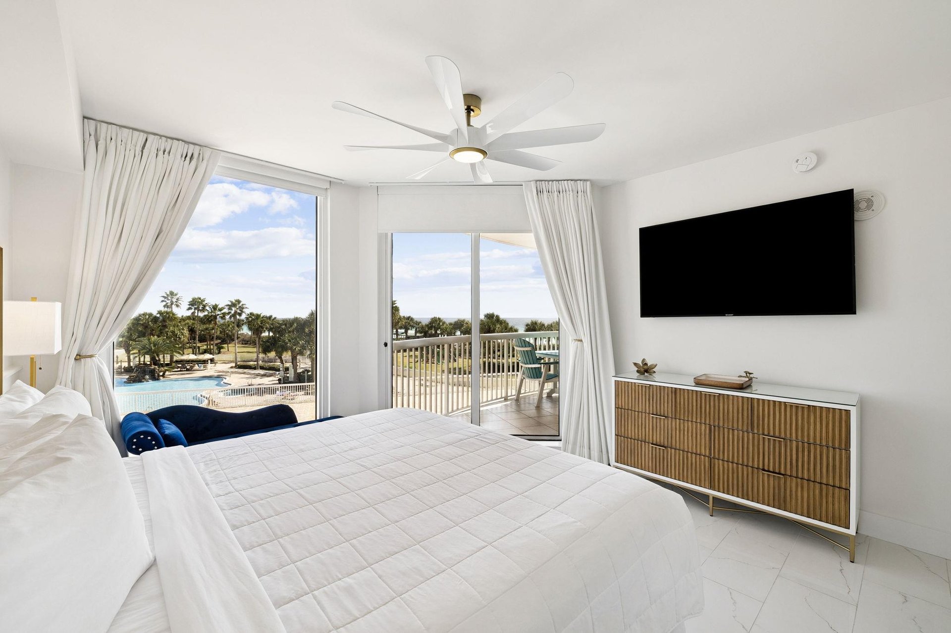 Wake up to stunning pool views from your bright, airy bedroom with modern furnishings and private balcony access.