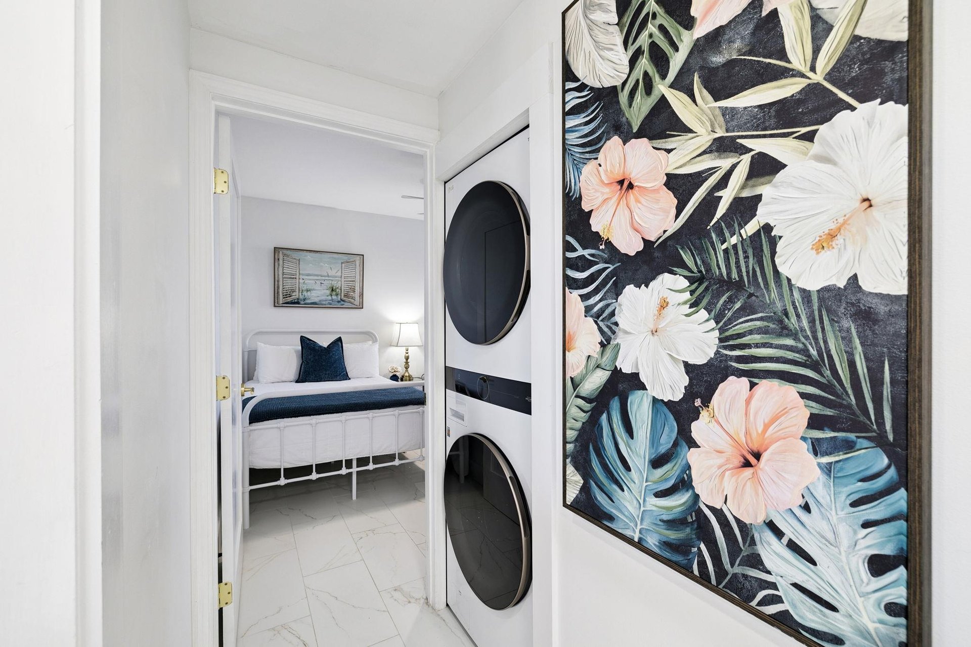 Your laundry day becomes a tropical escape with vibrant botanical art brightening your private washer and dryer space.