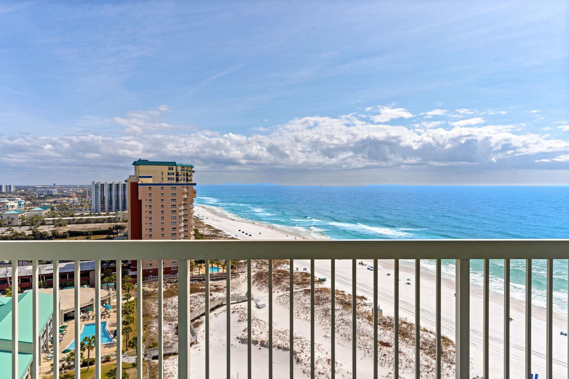 Sweeping beachfront views showcase pristine white sand and turquoise waters.