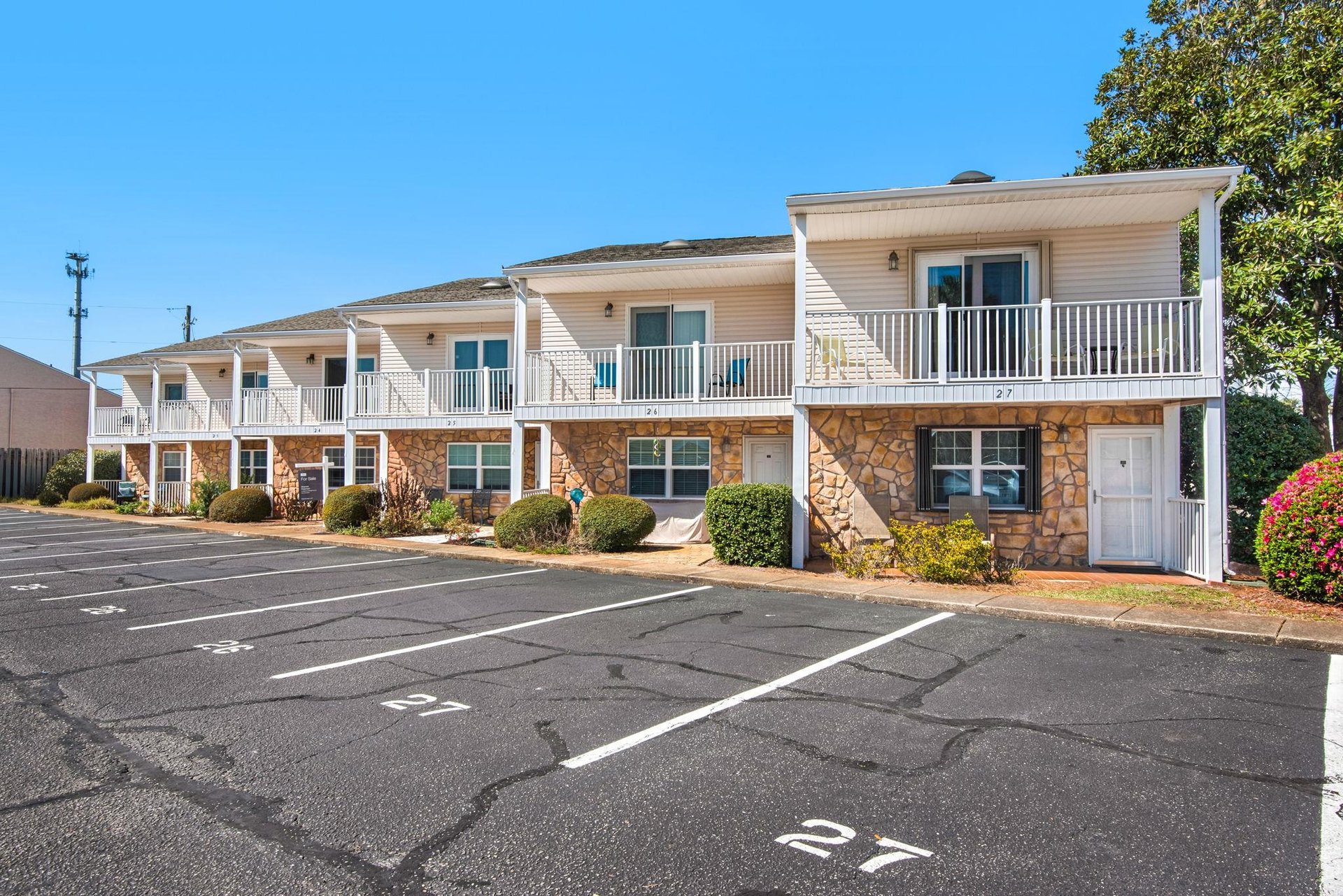 Twostory building with reserved parking spaces and landscaped grounds.