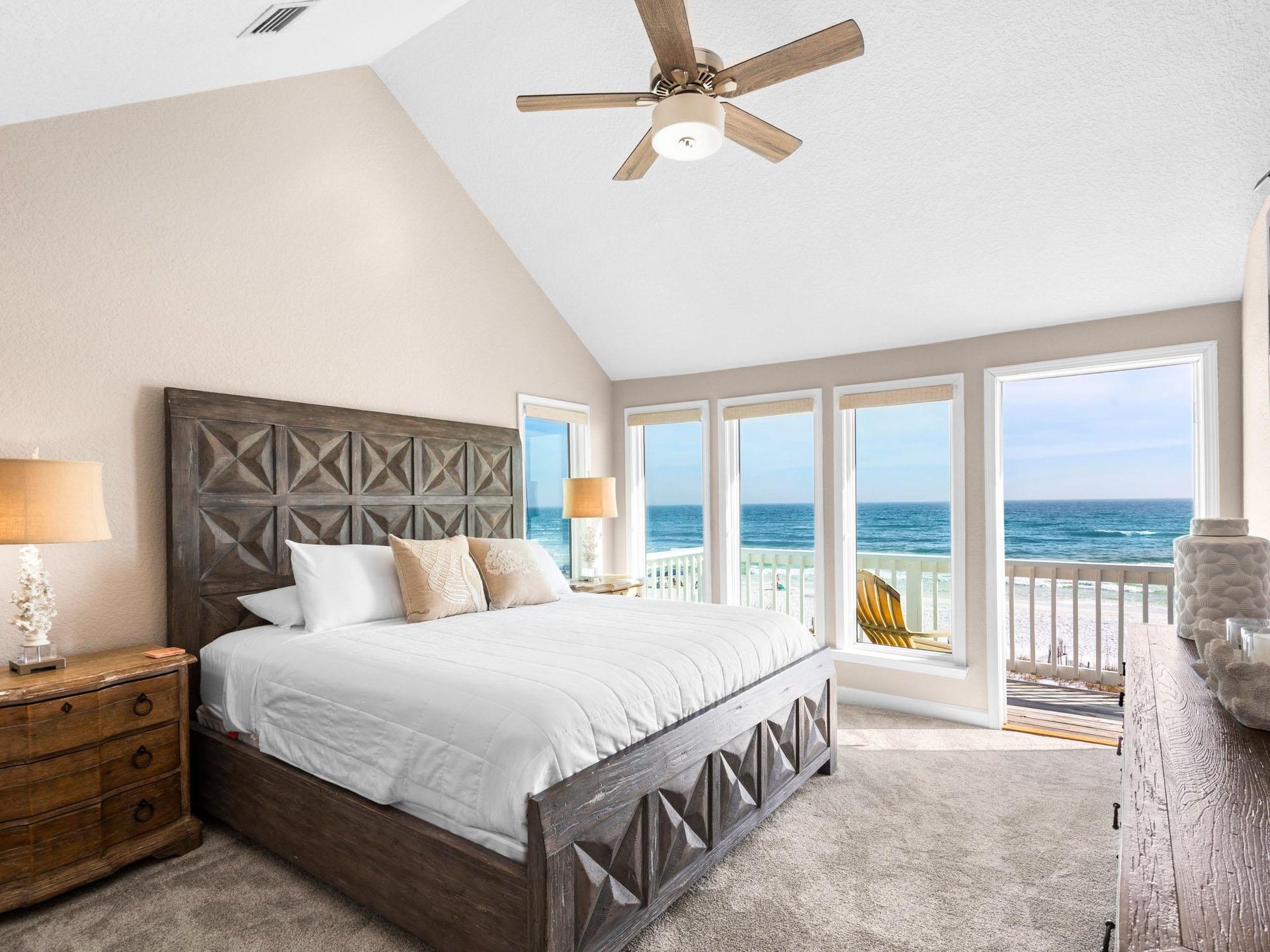 Bedroom 1  Wake to endless Gulf views from your comfortable bed, where gentle sea breezes flow through open doors to your private beach balcony.